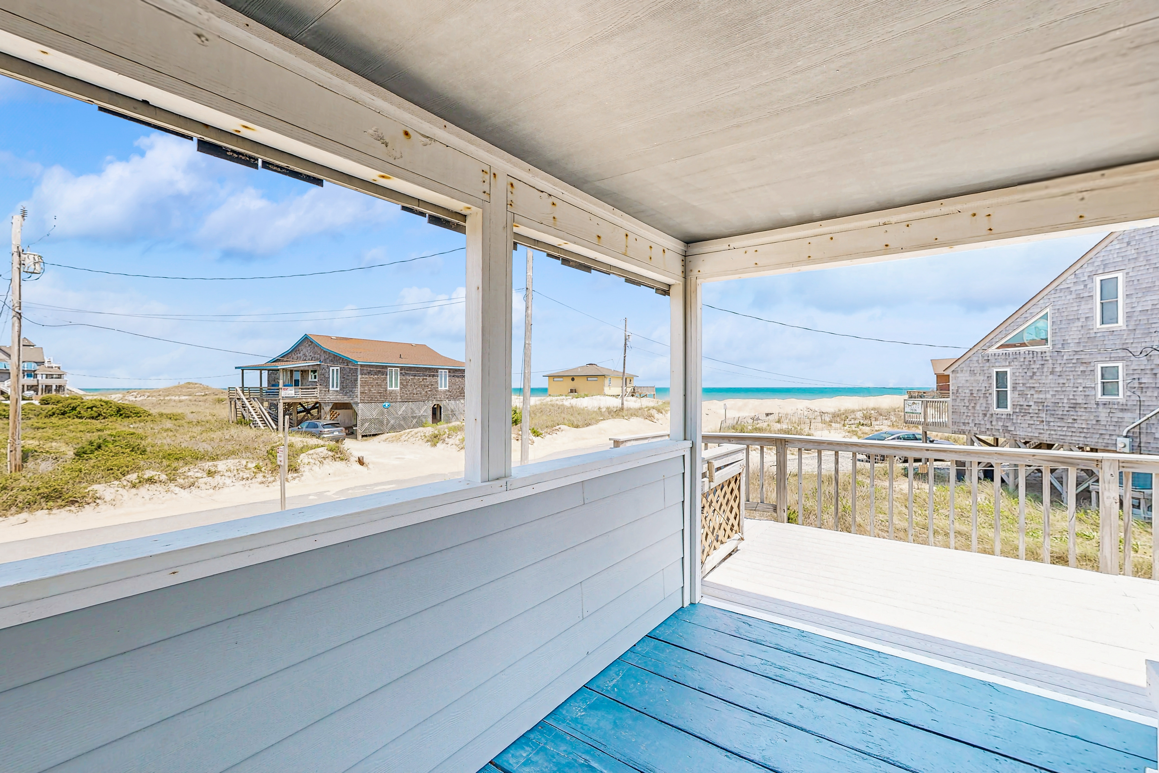 Ocean-view home steps from the beach with deck, outdoor shower, & central AC