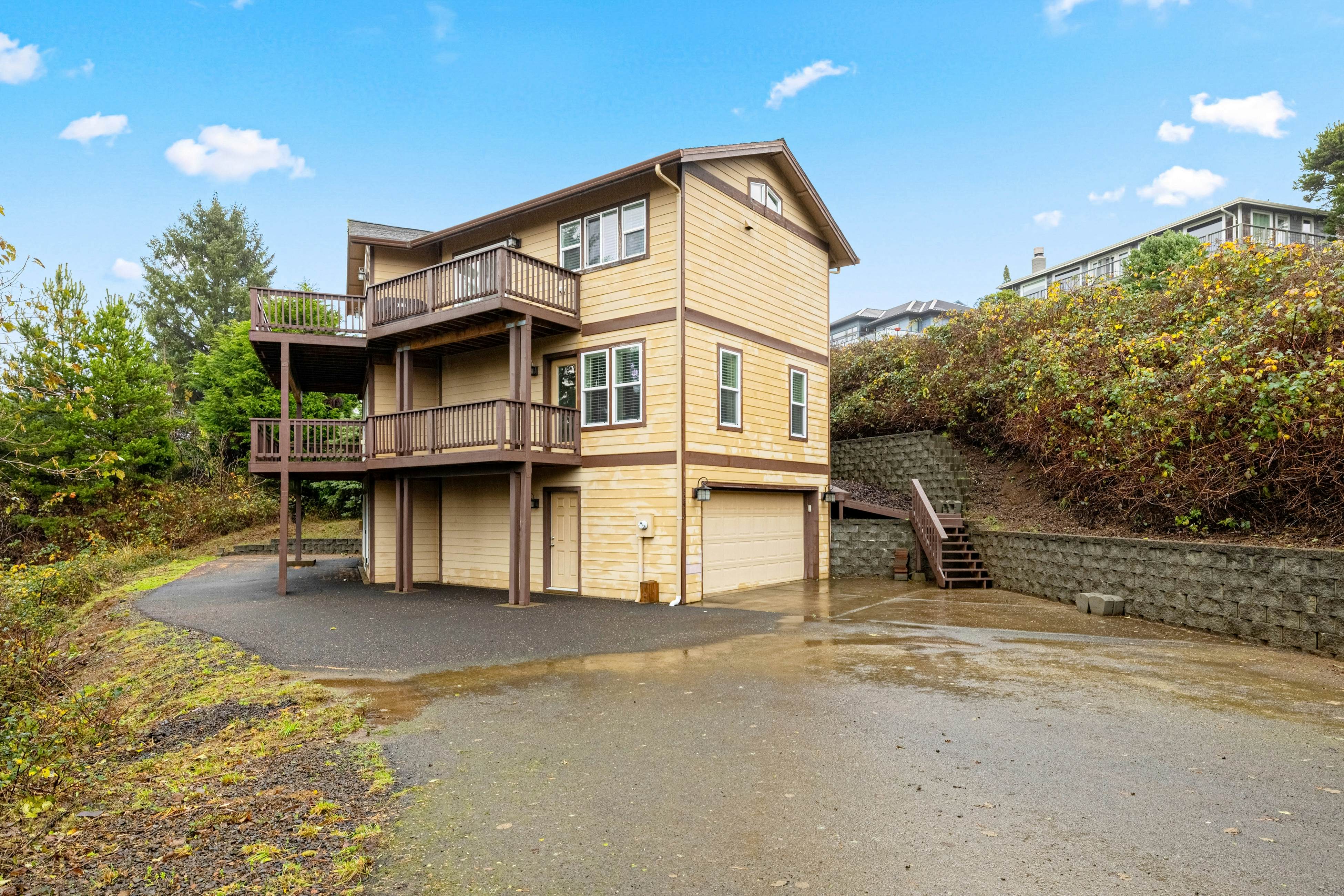 Three-story ocean view home with balconies, grill, & open layout - dog-friendly