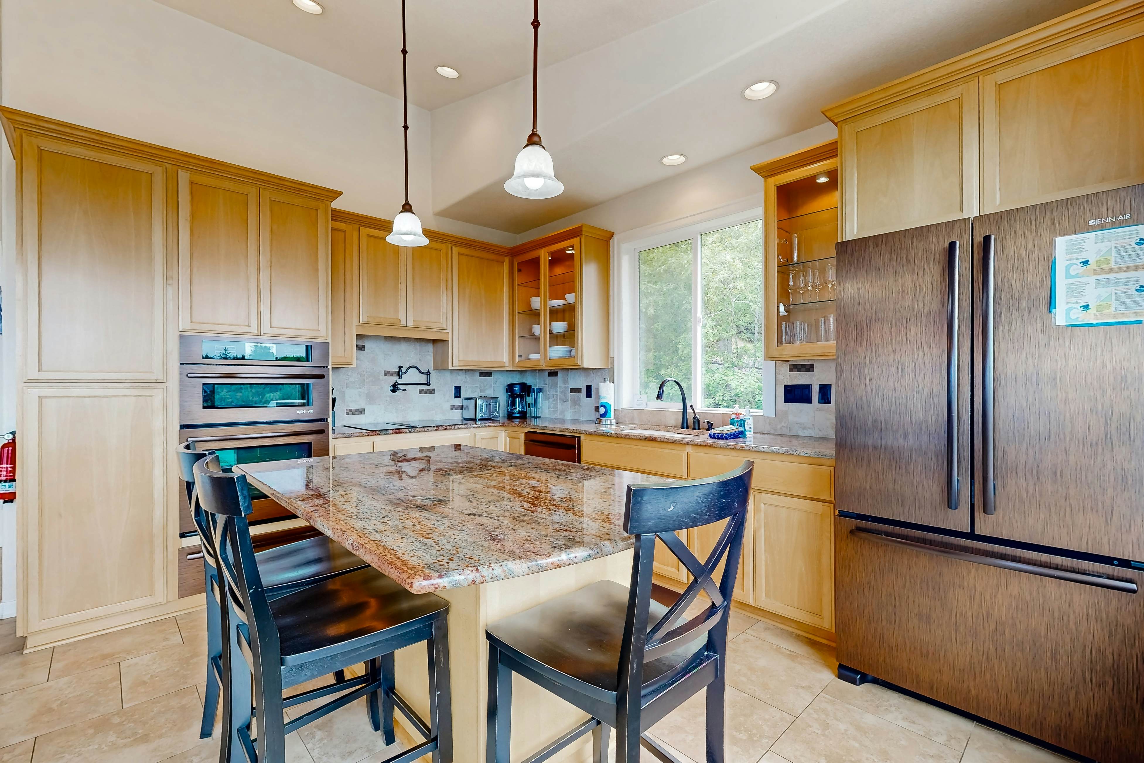 Ocean view home with heated floors, private hot tub, & multiple decks