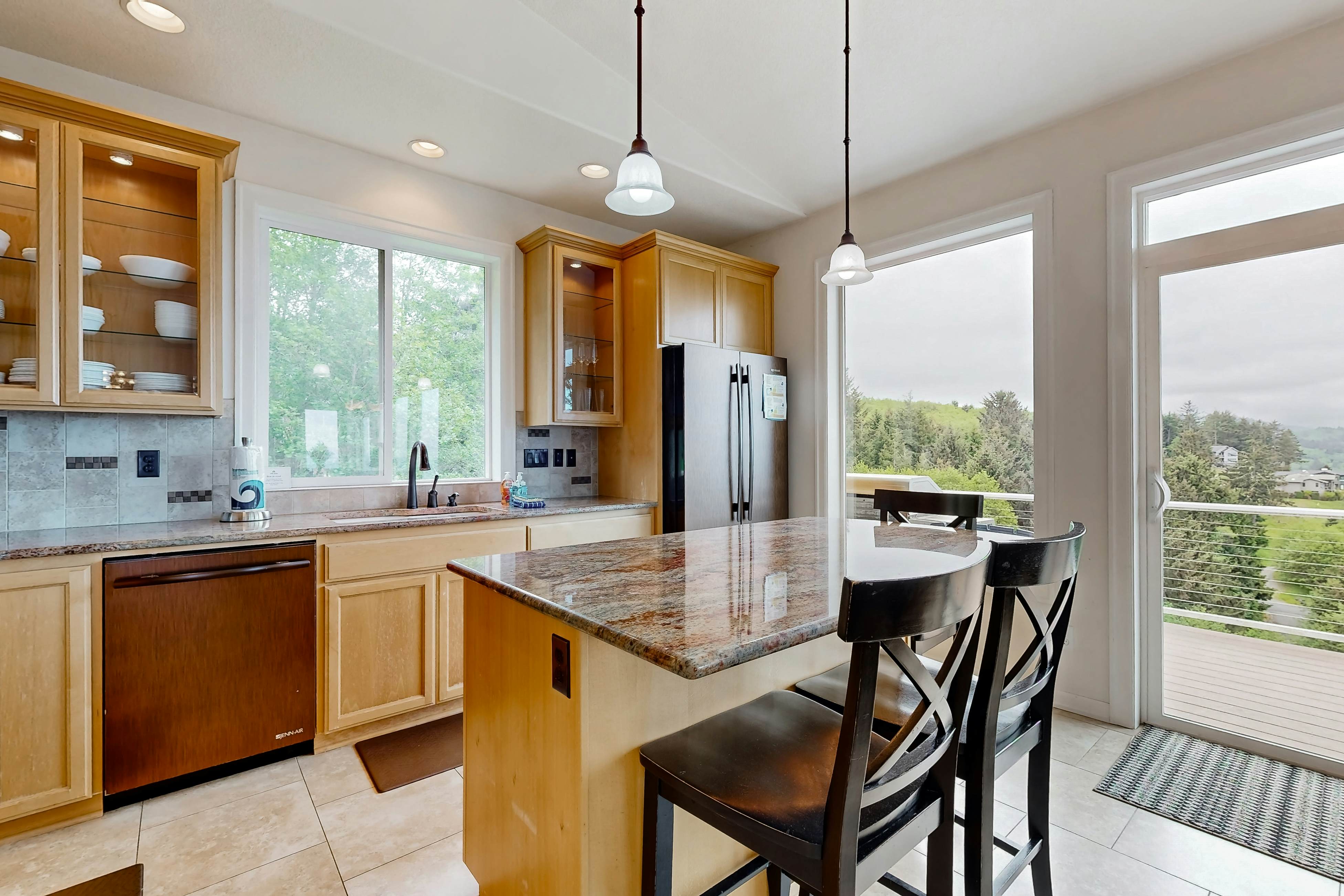 Ocean view home with heated floors, private hot tub, & multiple decks