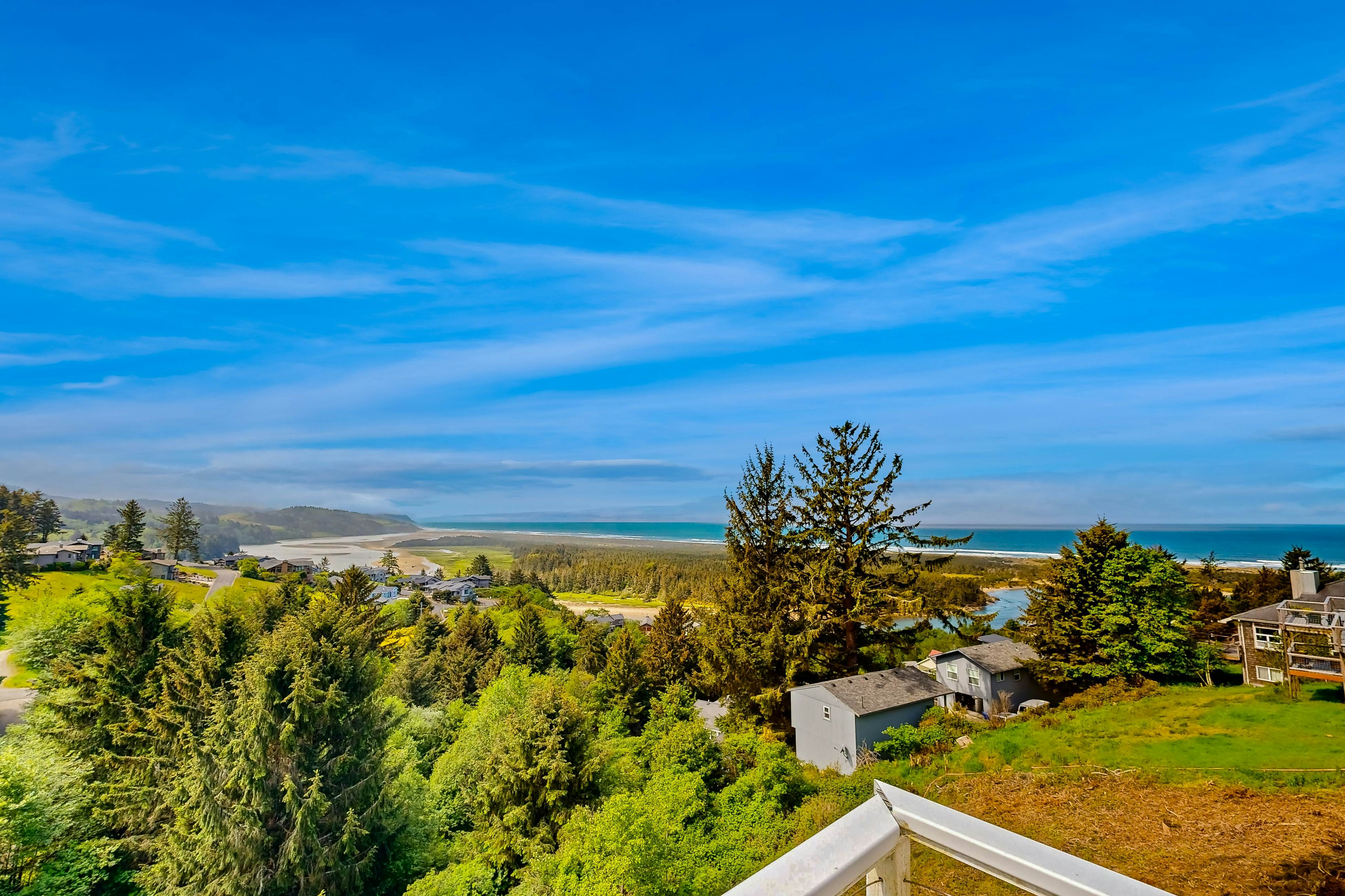 Ocean view home with heated floors, private hot tub, & multiple decks