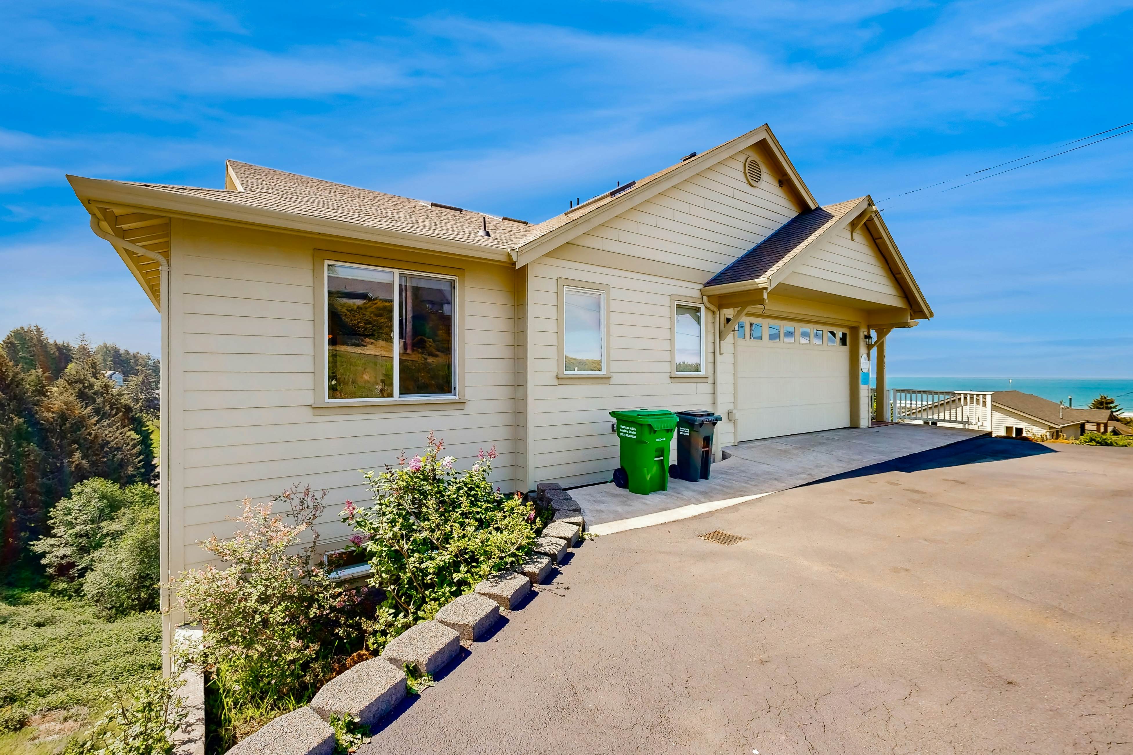 Ocean view home with heated floors, private hot tub, & multiple decks