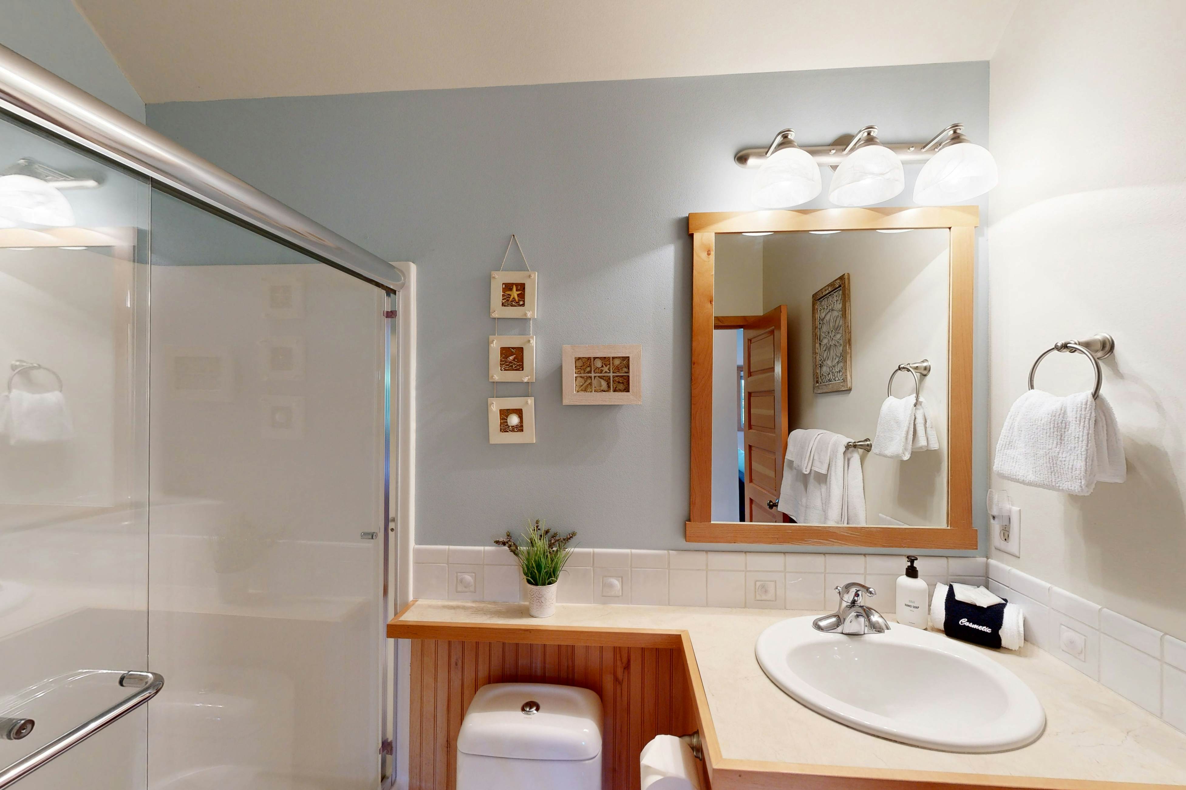 Coastal home walking distance to the beach with outdoor shower & fireplace