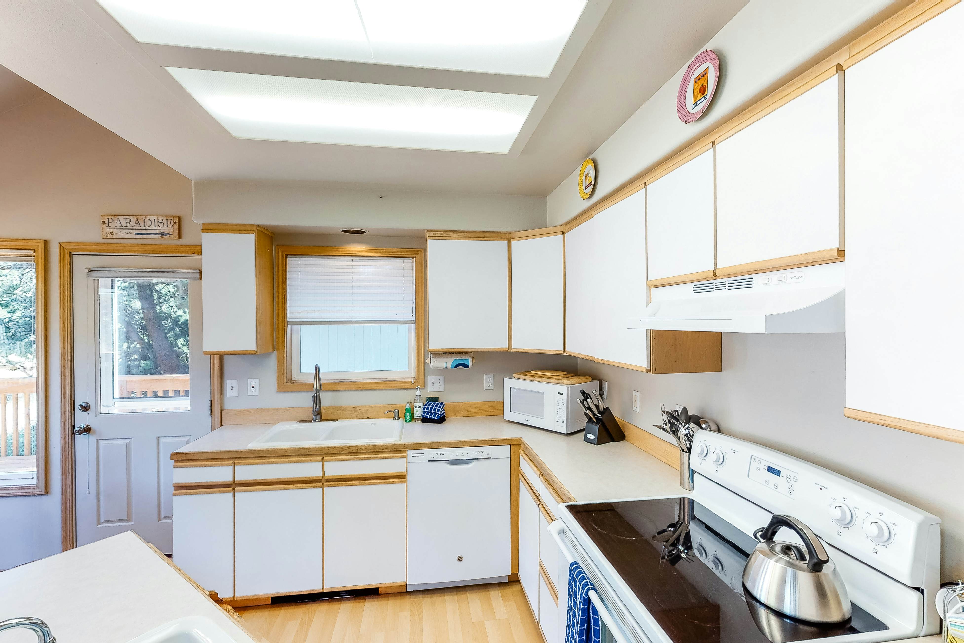 Bright dog-friendly home with wrap-around deck just steps from beach