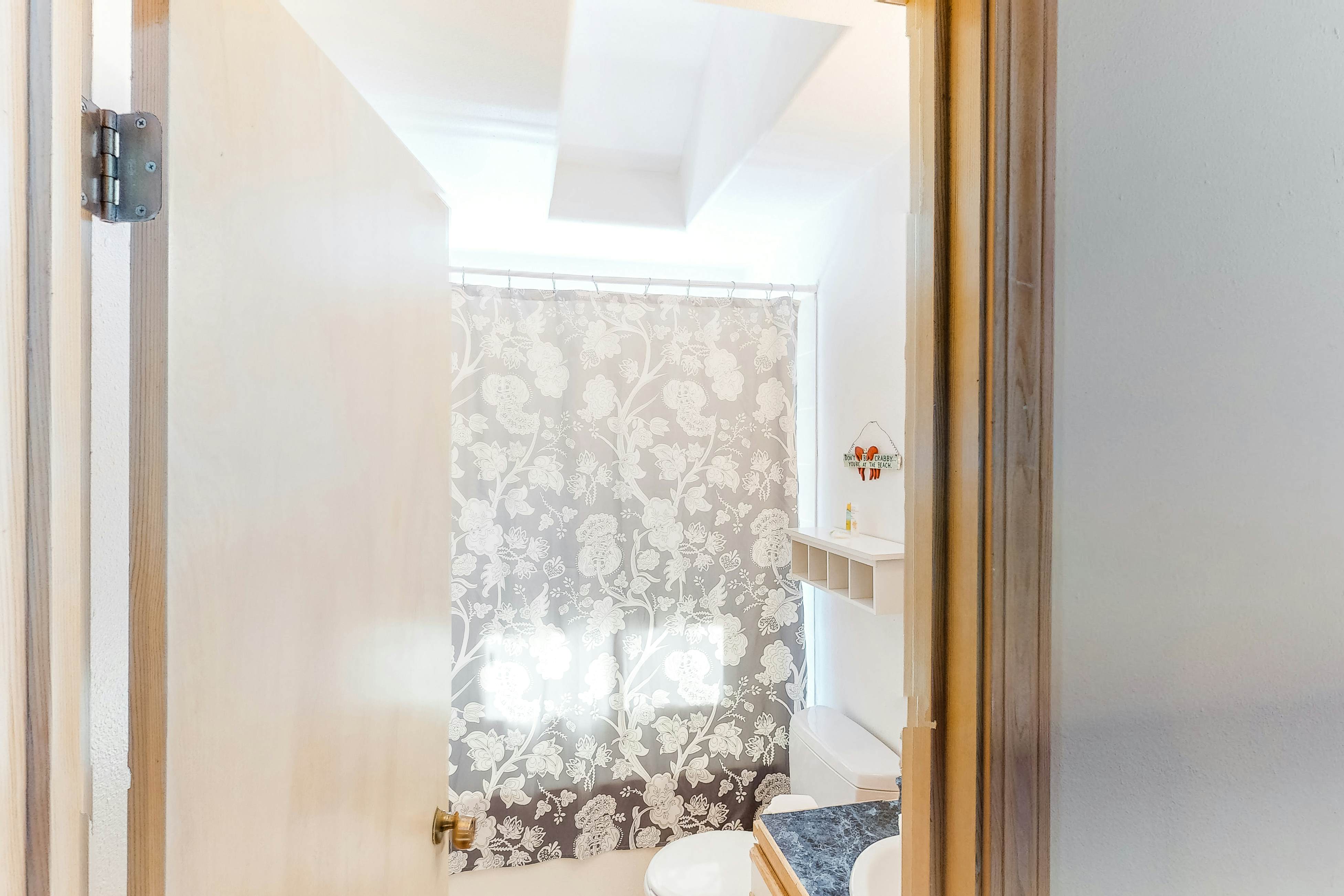 Bright dog-friendly home with wrap-around deck just steps from beach