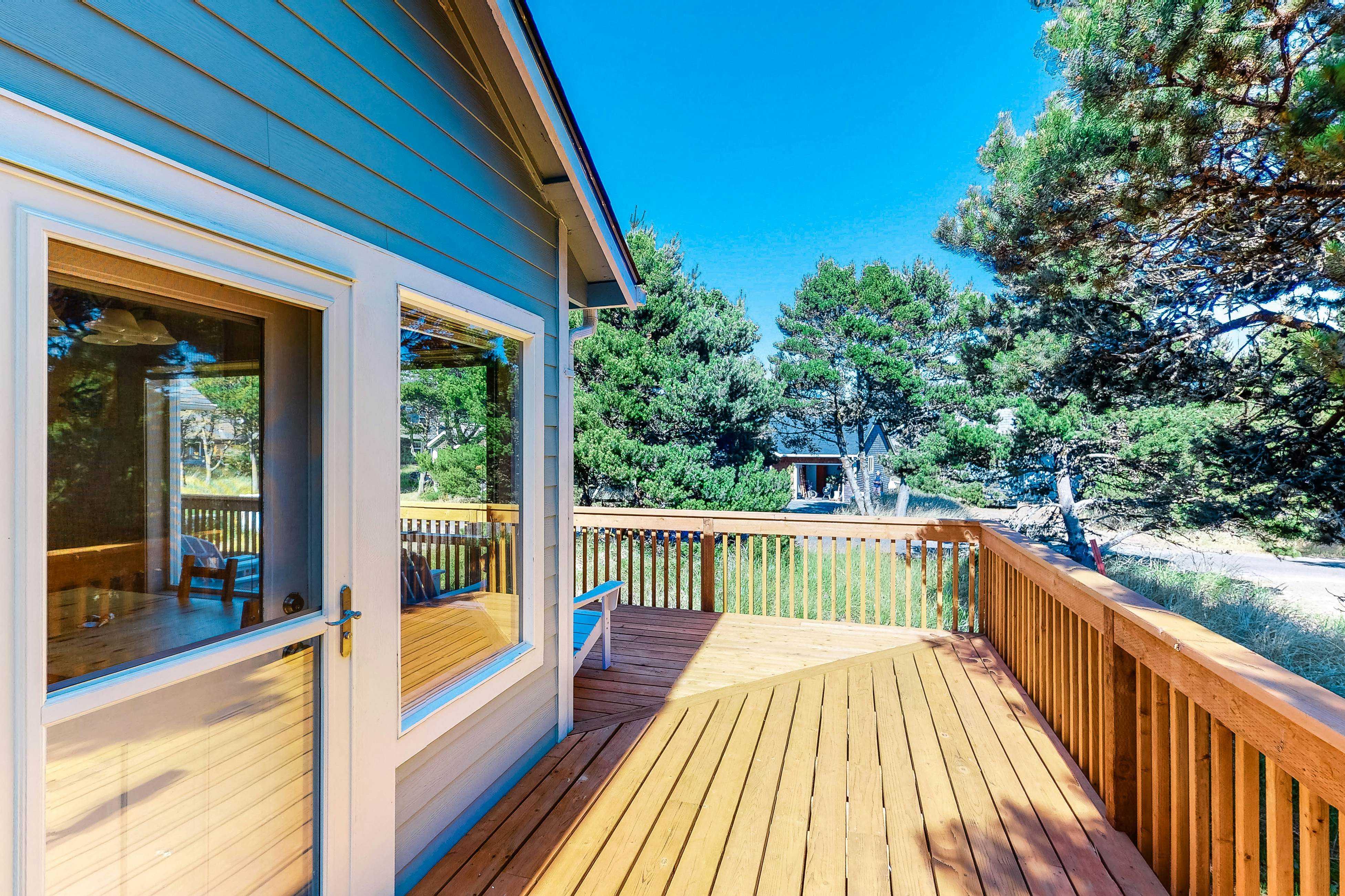 Bright dog-friendly home with wrap-around deck just steps from beach