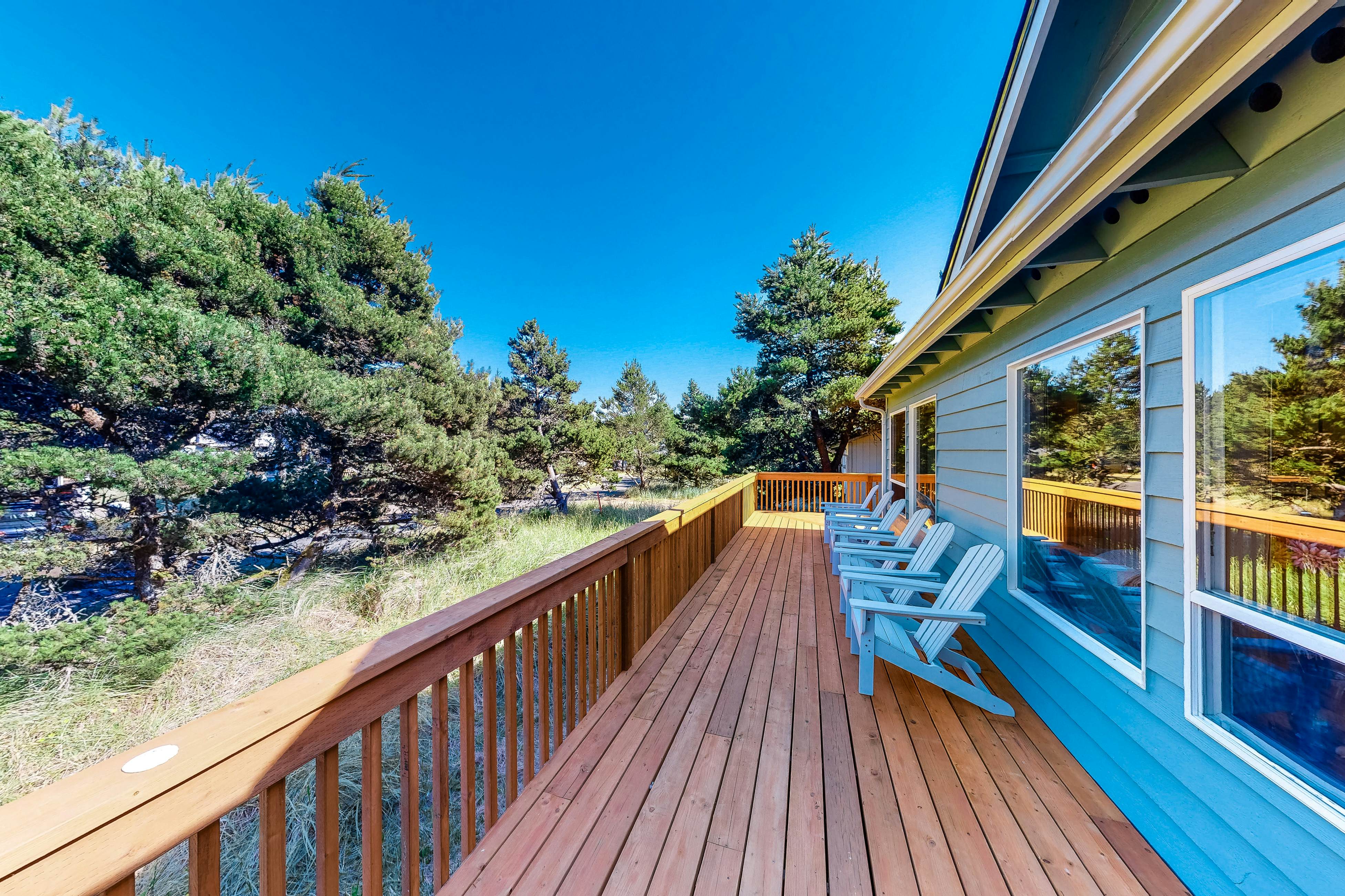 Bright dog-friendly home with wrap-around deck just steps from beach