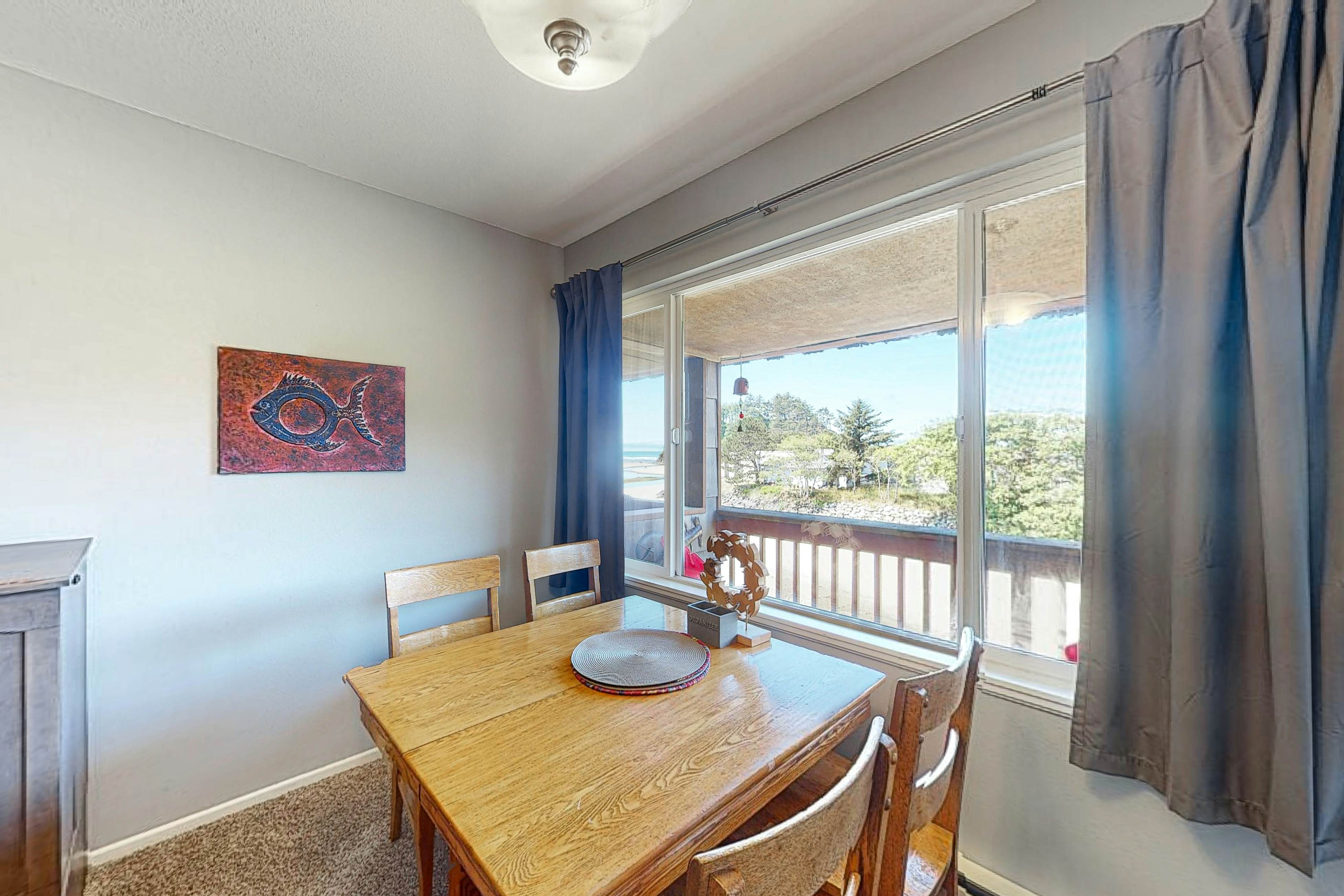 Third-floor beachfront condo with a balcony, full kitchen, & ocean views