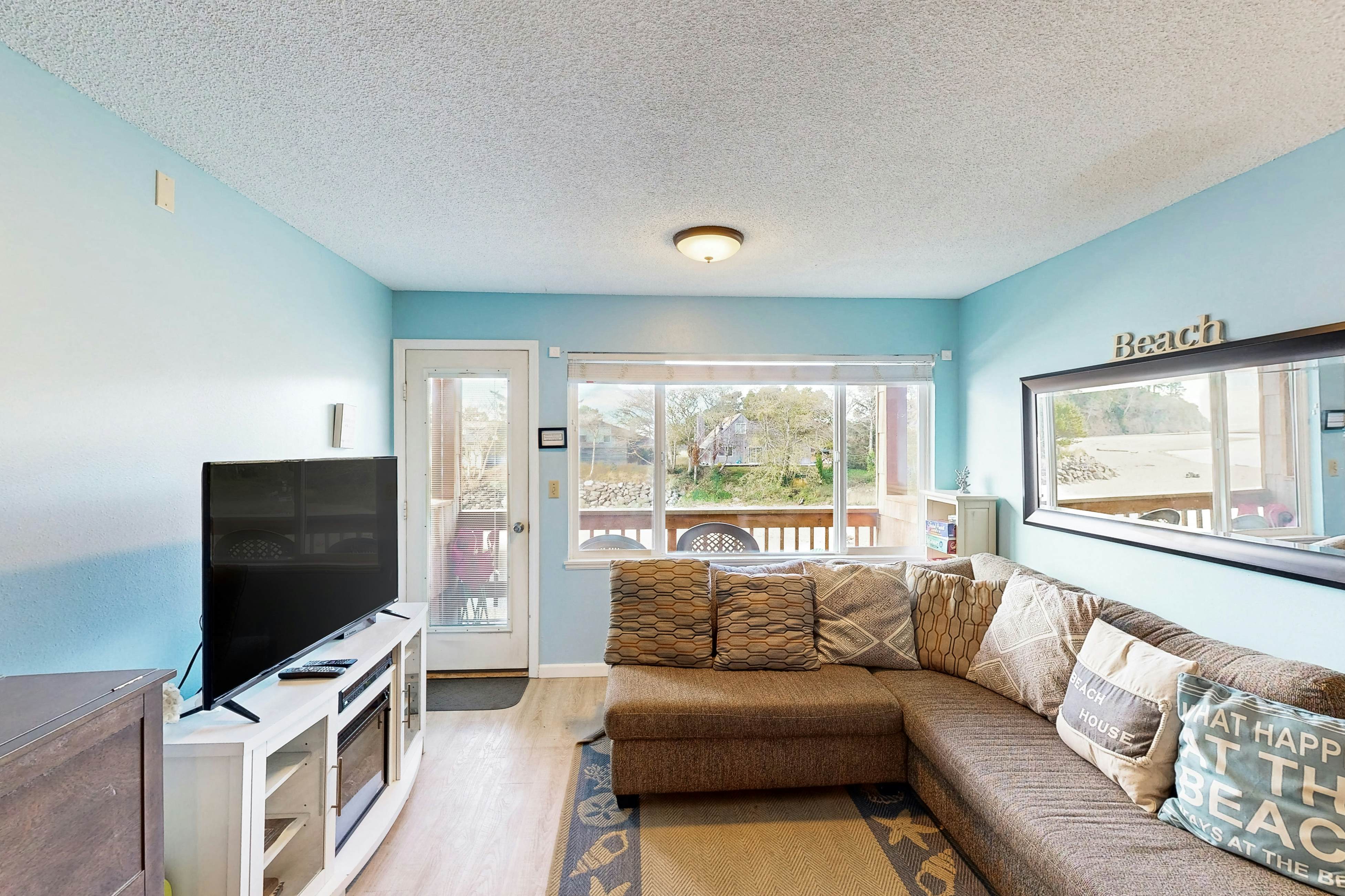 Creekside condo with beach access, balcony, full kitchen, & ocean views