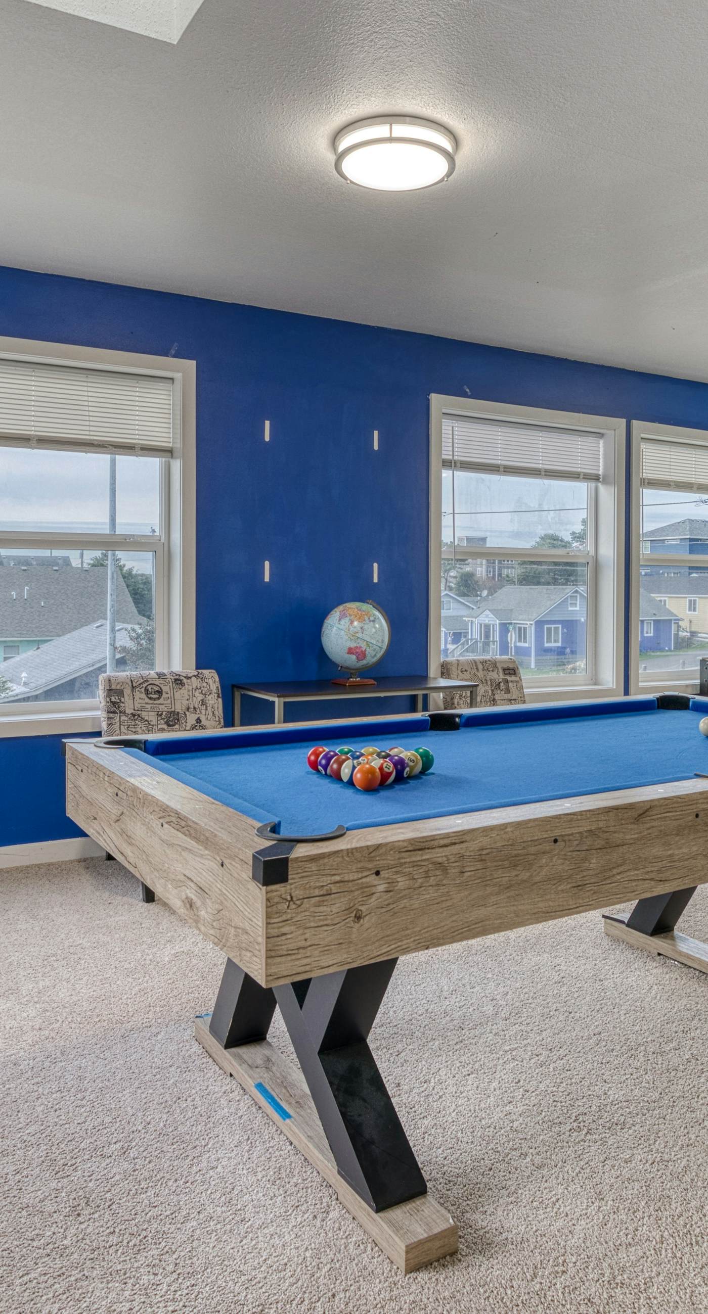 Ocean view home with pool table and fast WiFi steps to beach shops and eateries