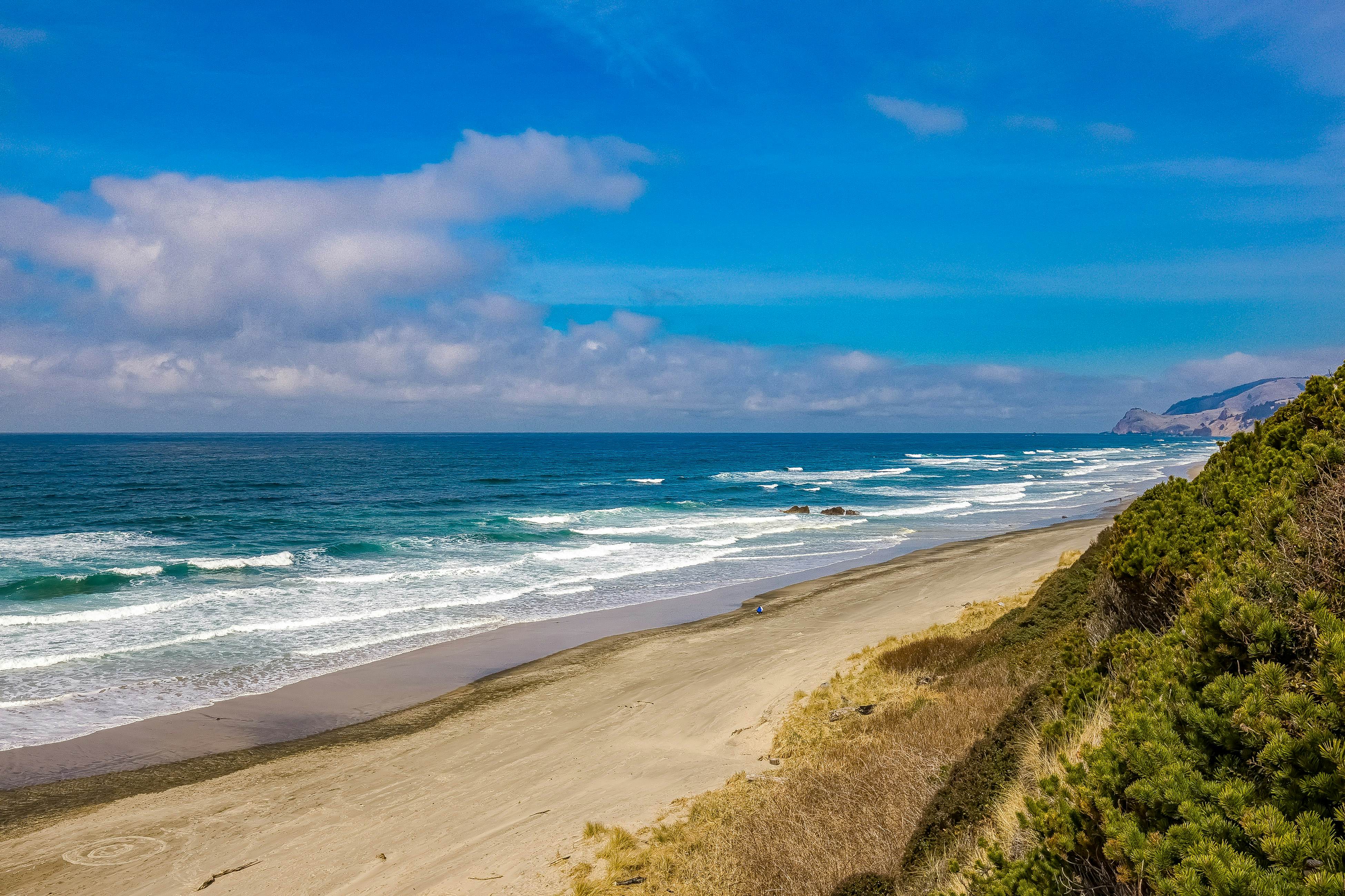 Ocean-view home 1 block from the beach with hot tub, deck, & fireplace