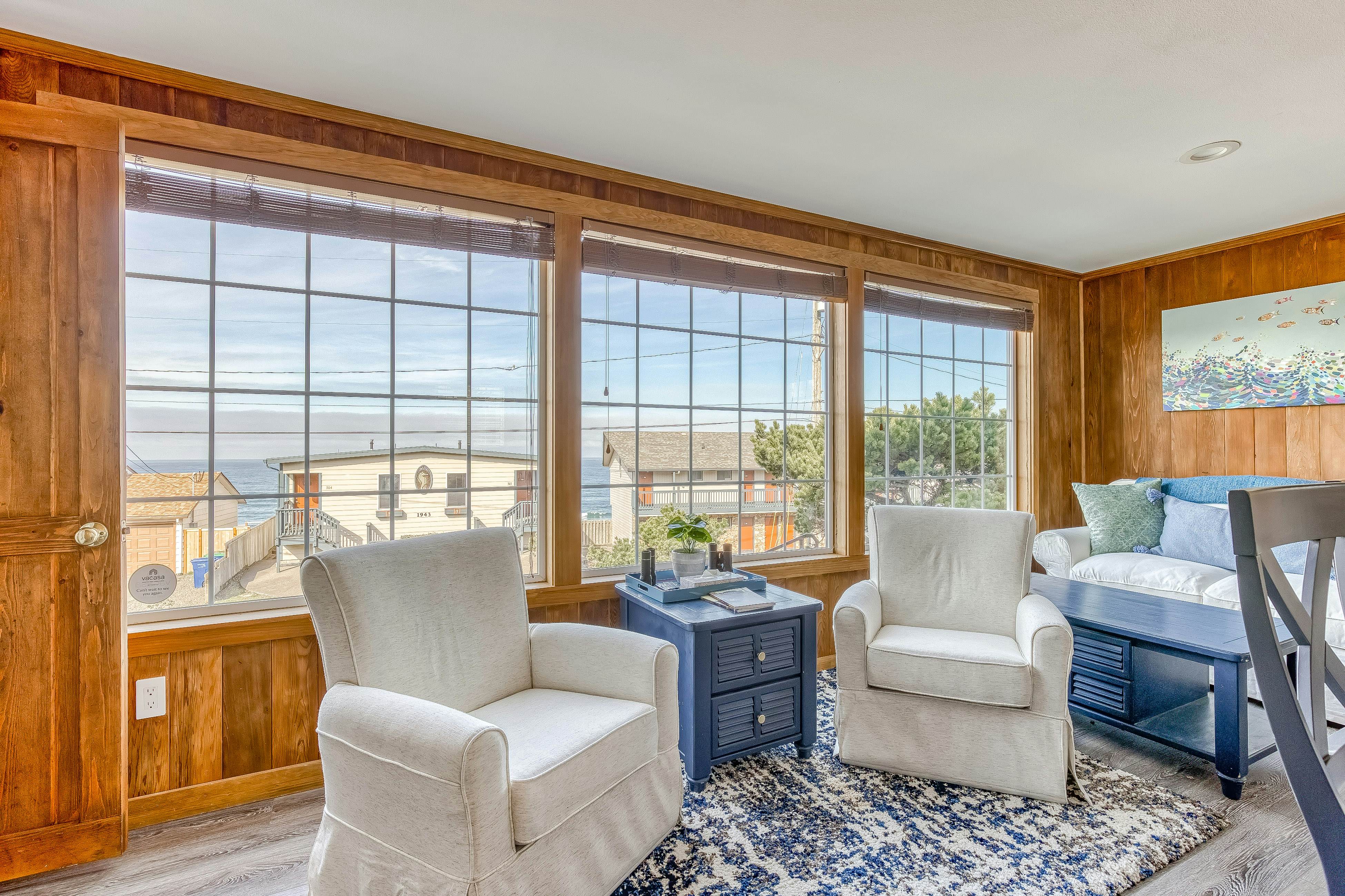 Ocean-view home 1 block from the beach with hot tub, deck, & fireplace