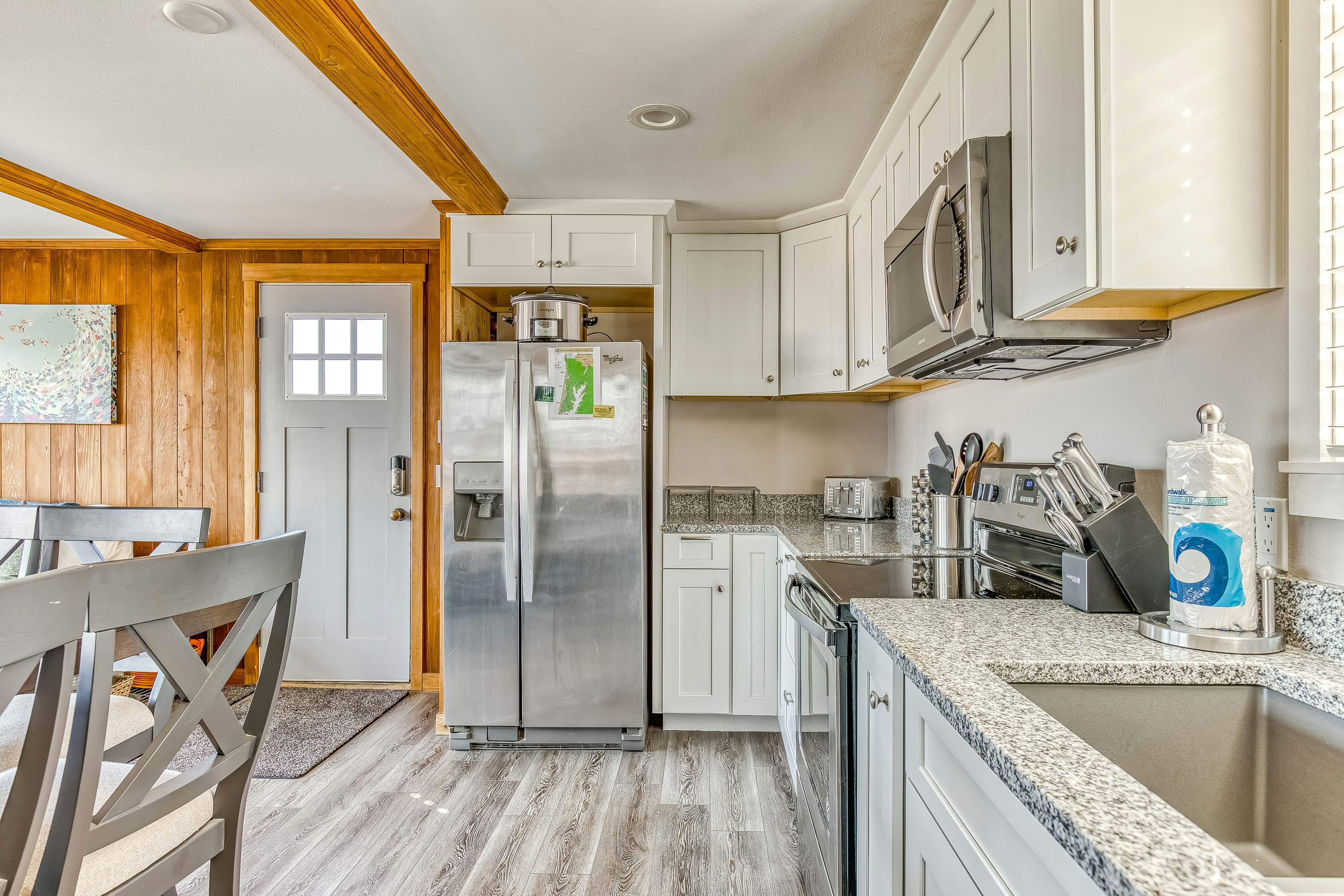 Ocean-view home 1 block from the beach with hot tub, deck, & fireplace