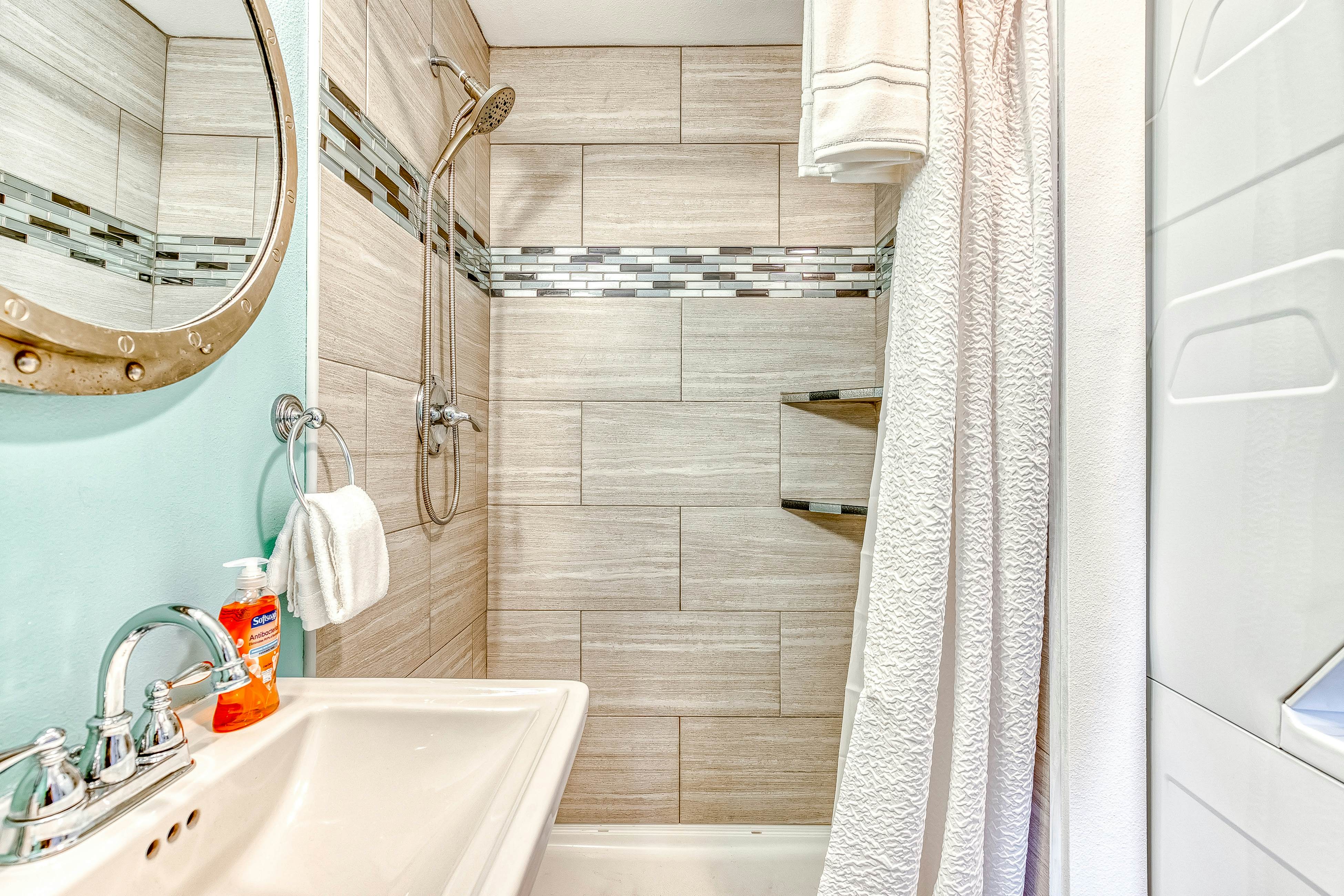 Ocean-view home 1 block from the beach with hot tub, deck, & fireplace