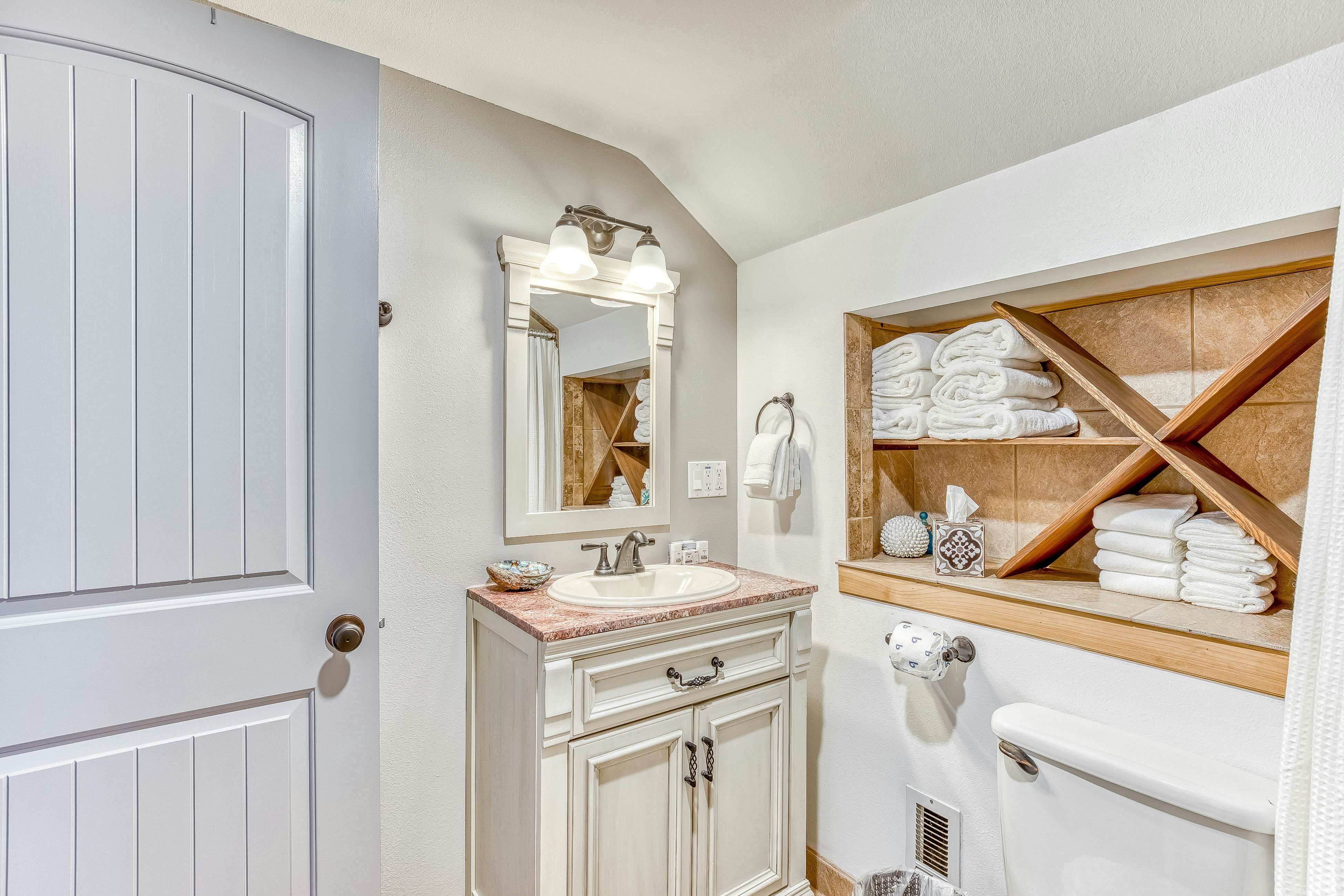 Ocean-view home 1 block from the beach with hot tub, deck, & fireplace