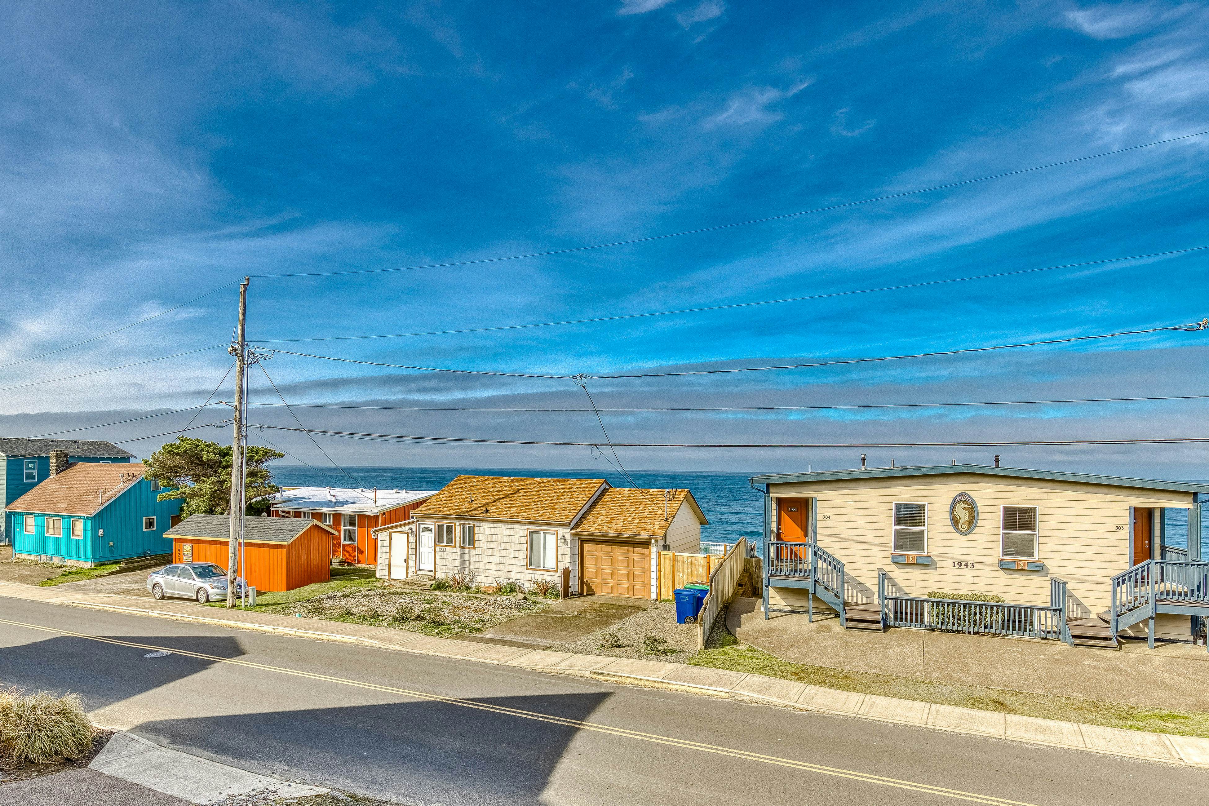 Ocean-view home 1 block from the beach with hot tub, deck, & fireplace