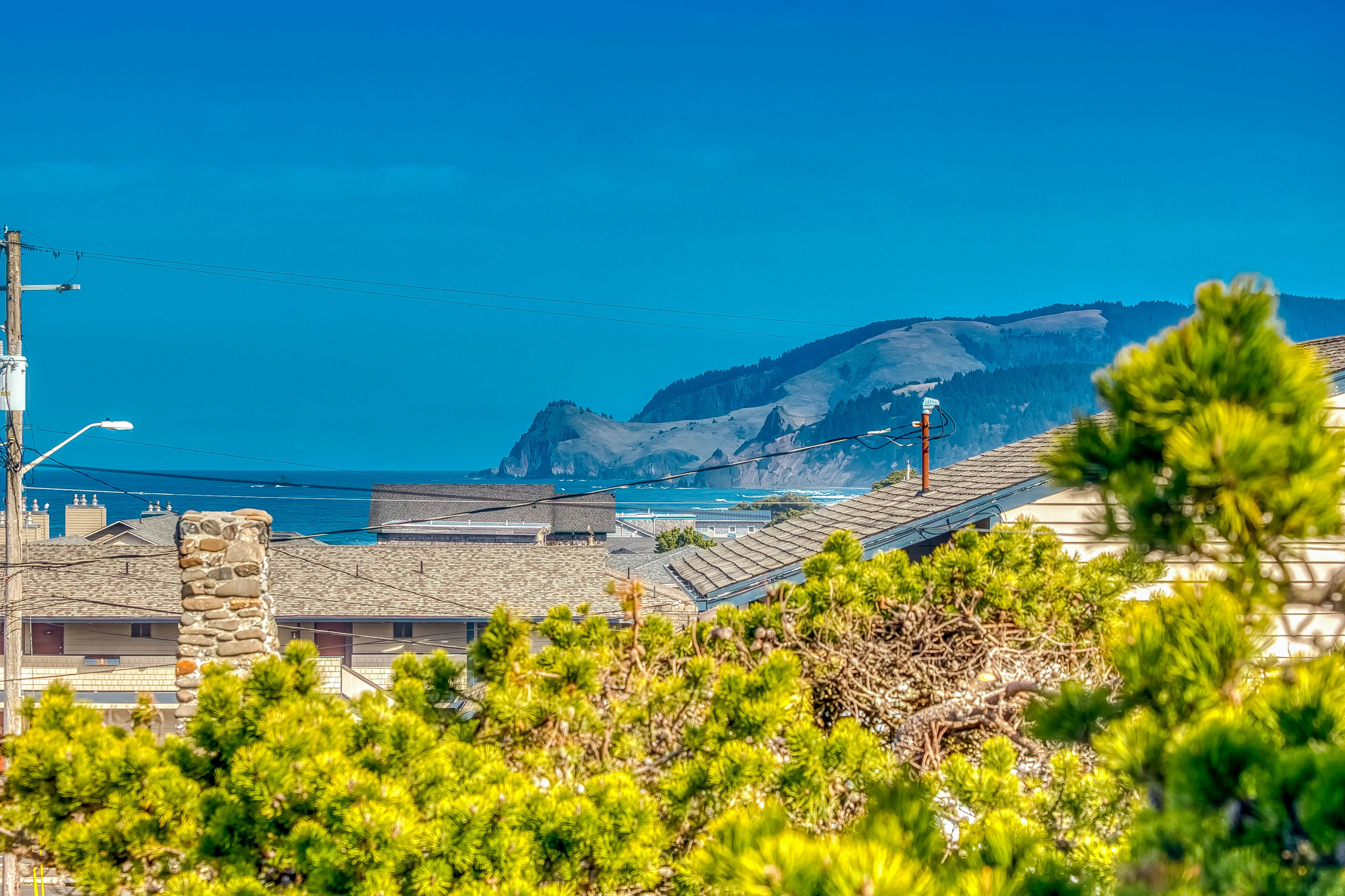 Ocean-view home 1 block from the beach with hot tub, deck, & fireplace