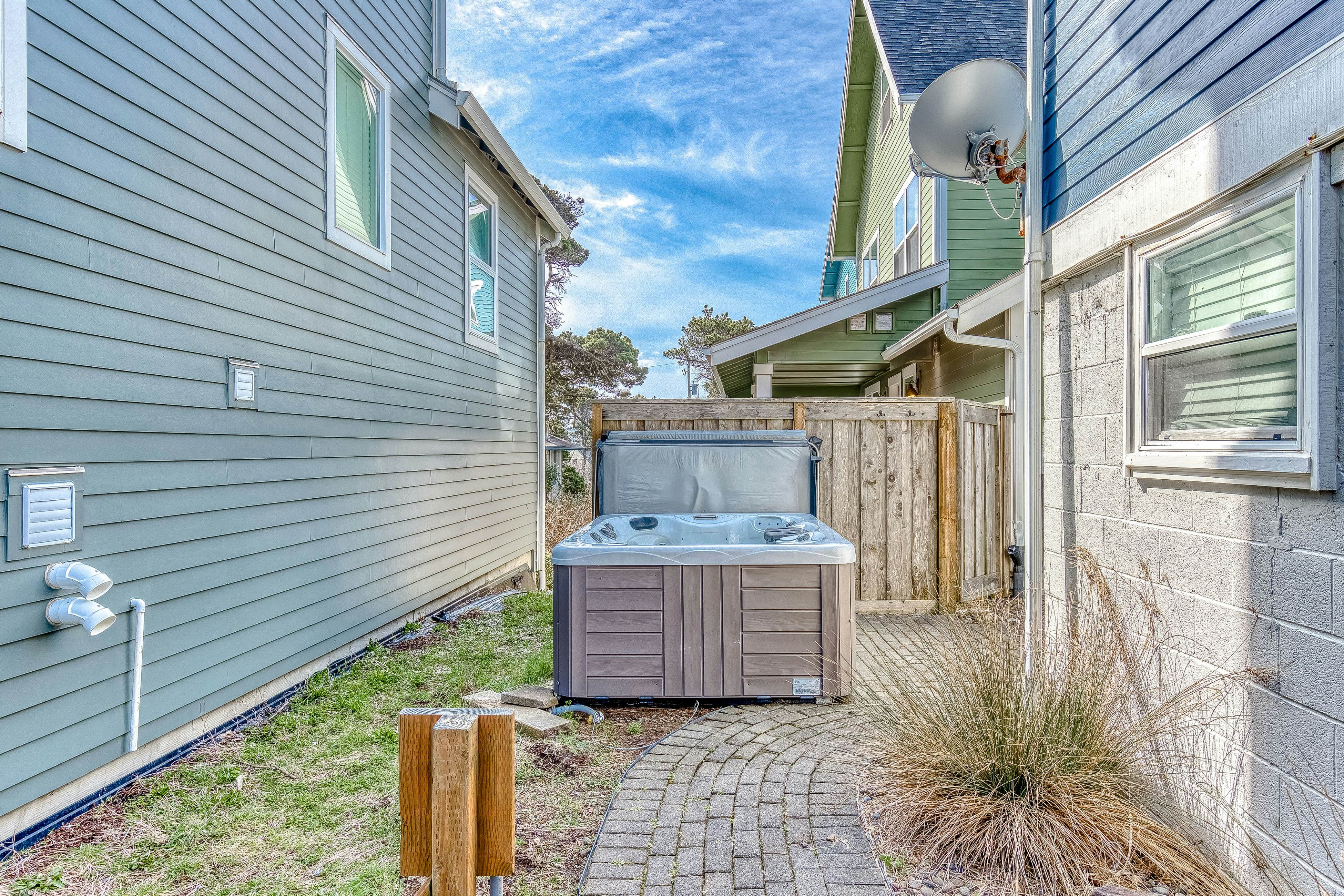 Ocean-view home 1 block from the beach with hot tub, deck, & fireplace