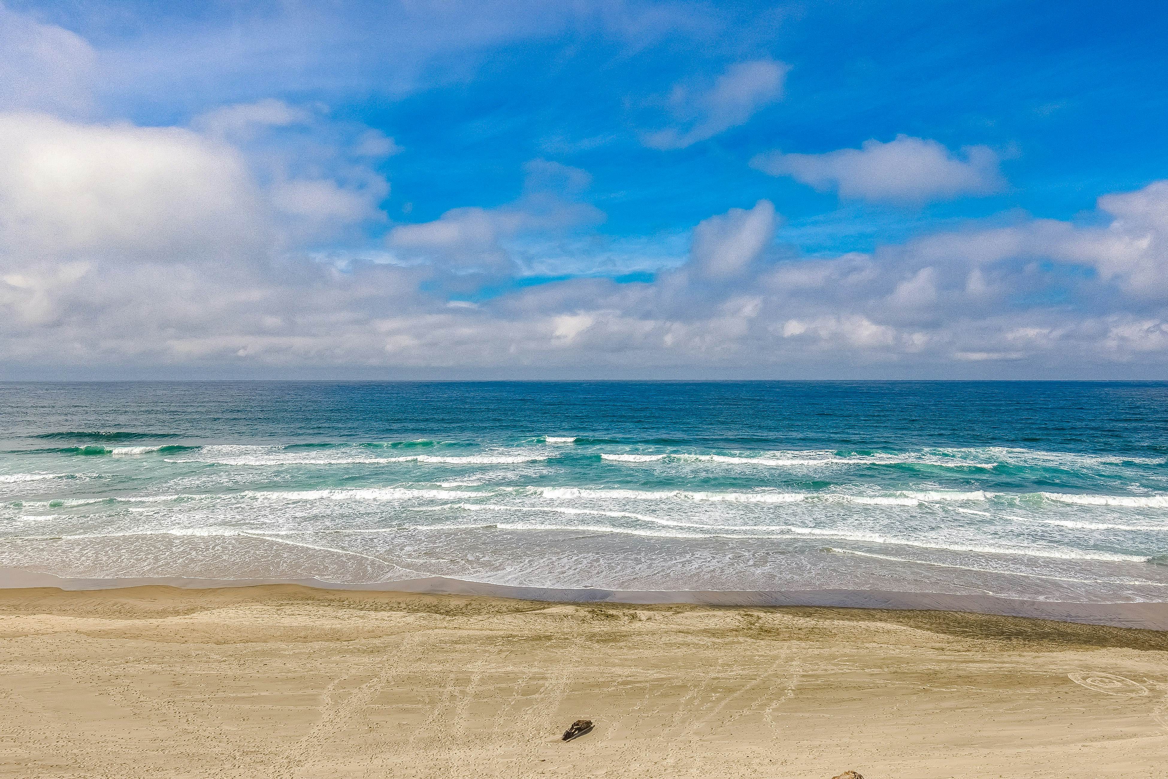 Ocean-view home 1 block from the beach with hot tub, deck, & fireplace