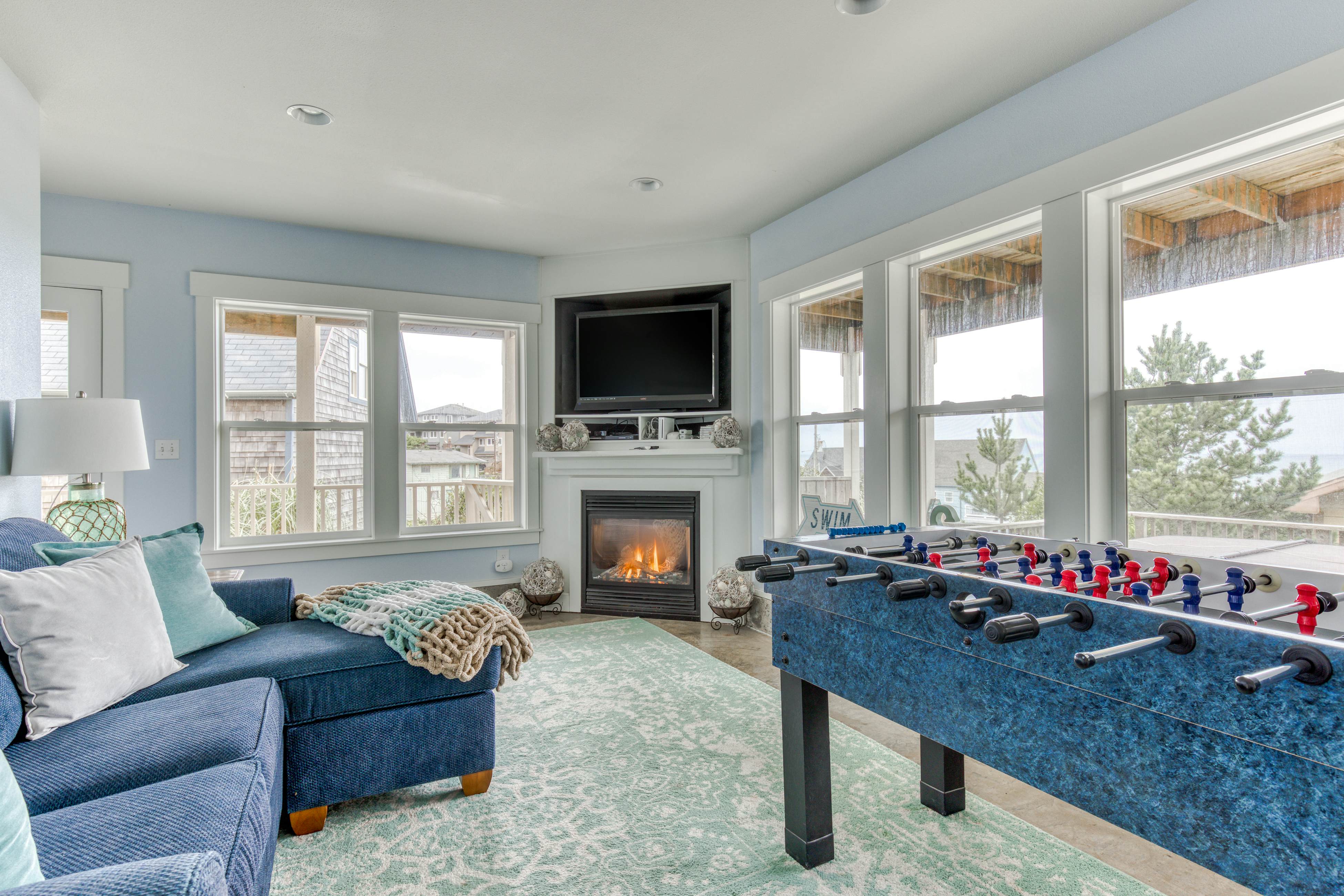 Ocean-view home with hot tub, game room, furnished deck, & fireplaces