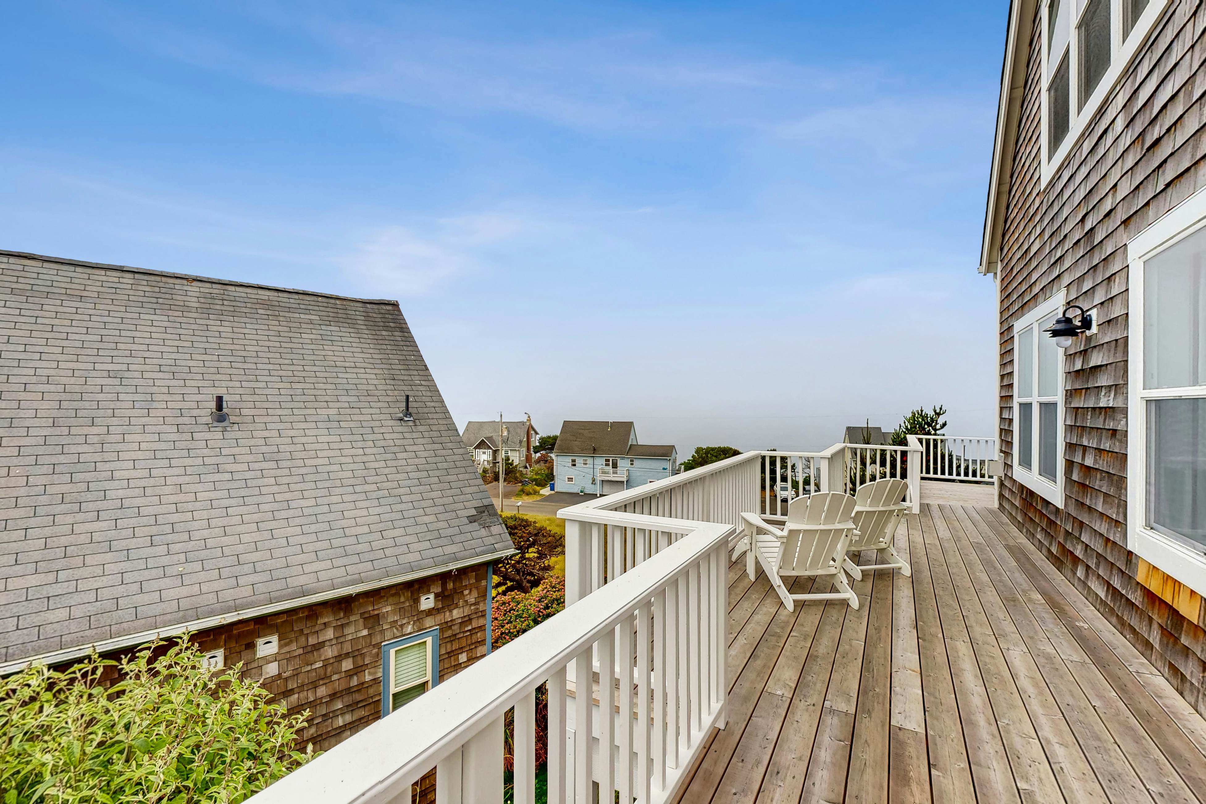 Ocean-view home with hot tub, game room, furnished deck, & fireplaces