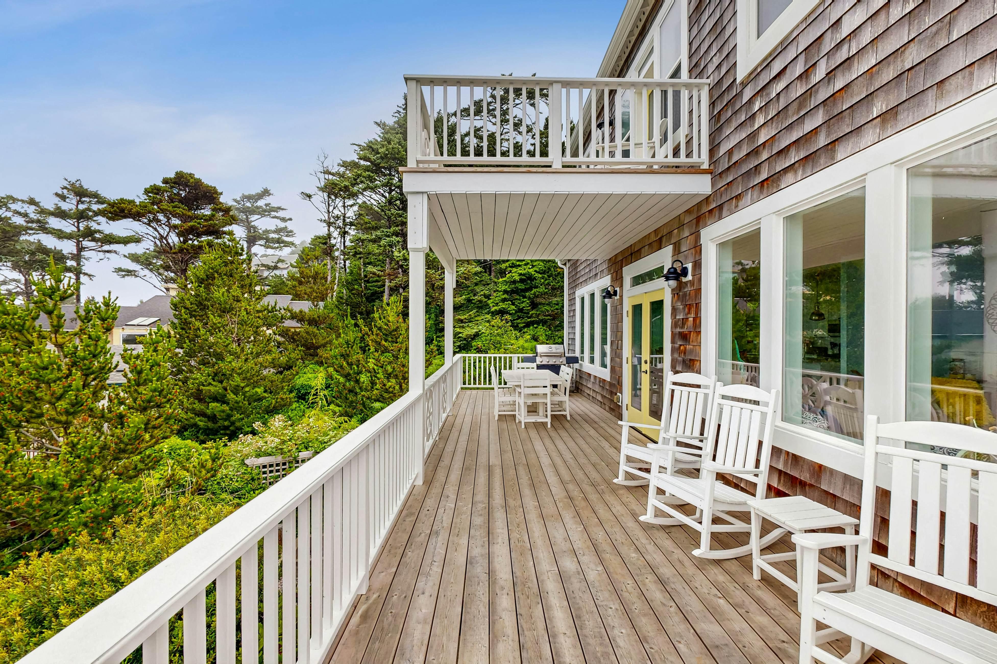 Ocean-view home with hot tub, game room, furnished deck, & fireplaces