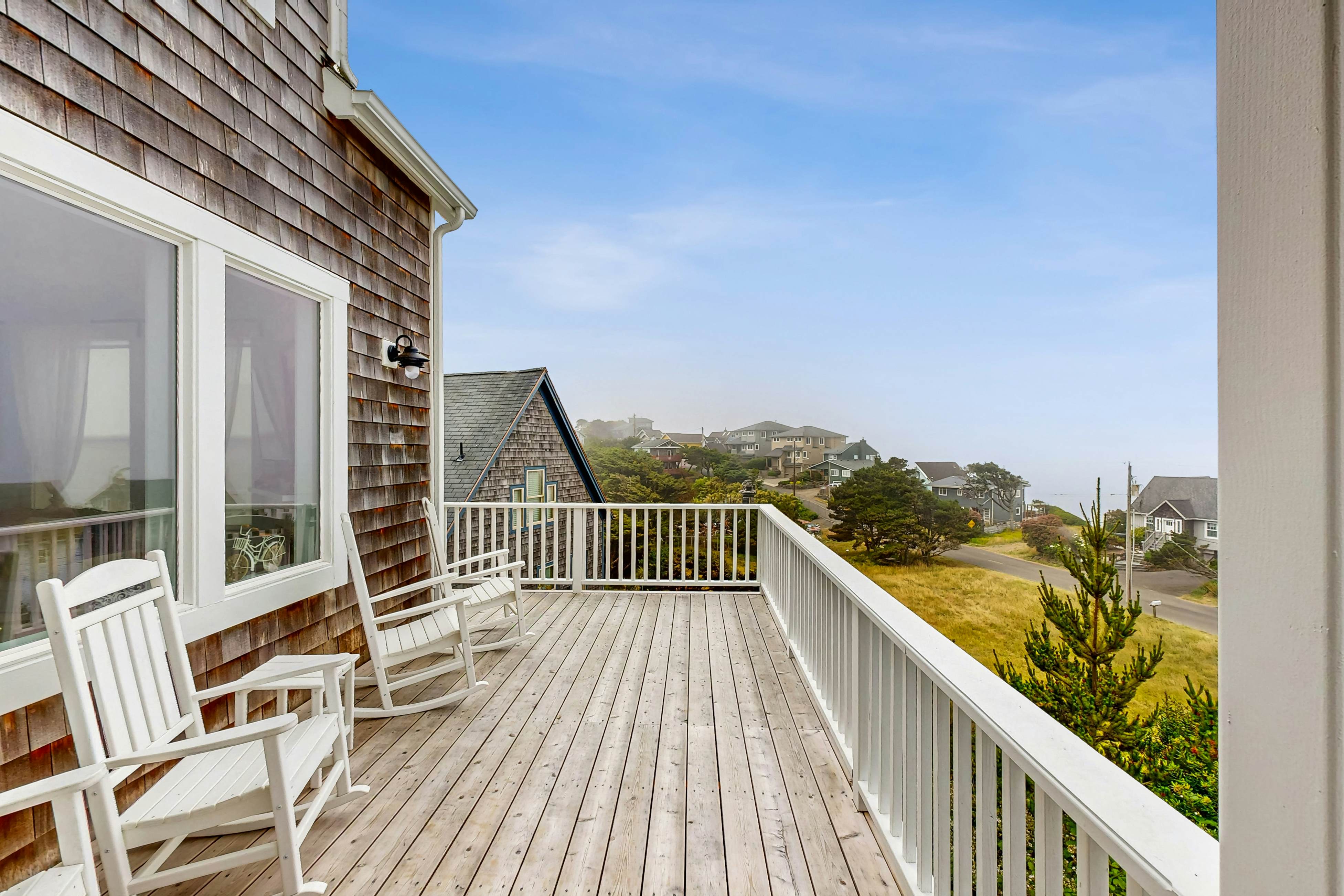 Ocean-view home with hot tub, game room, furnished deck, & fireplaces