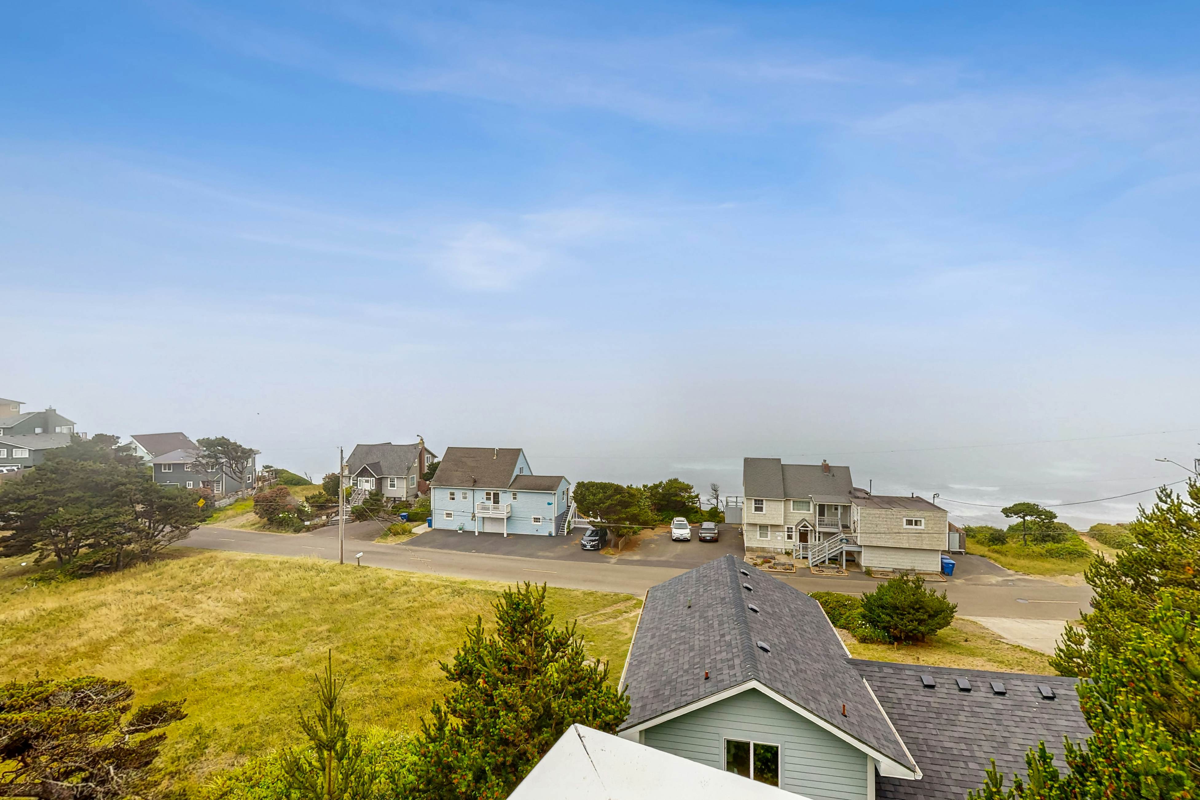 Ocean-view home with hot tub, game room, furnished deck, & fireplaces