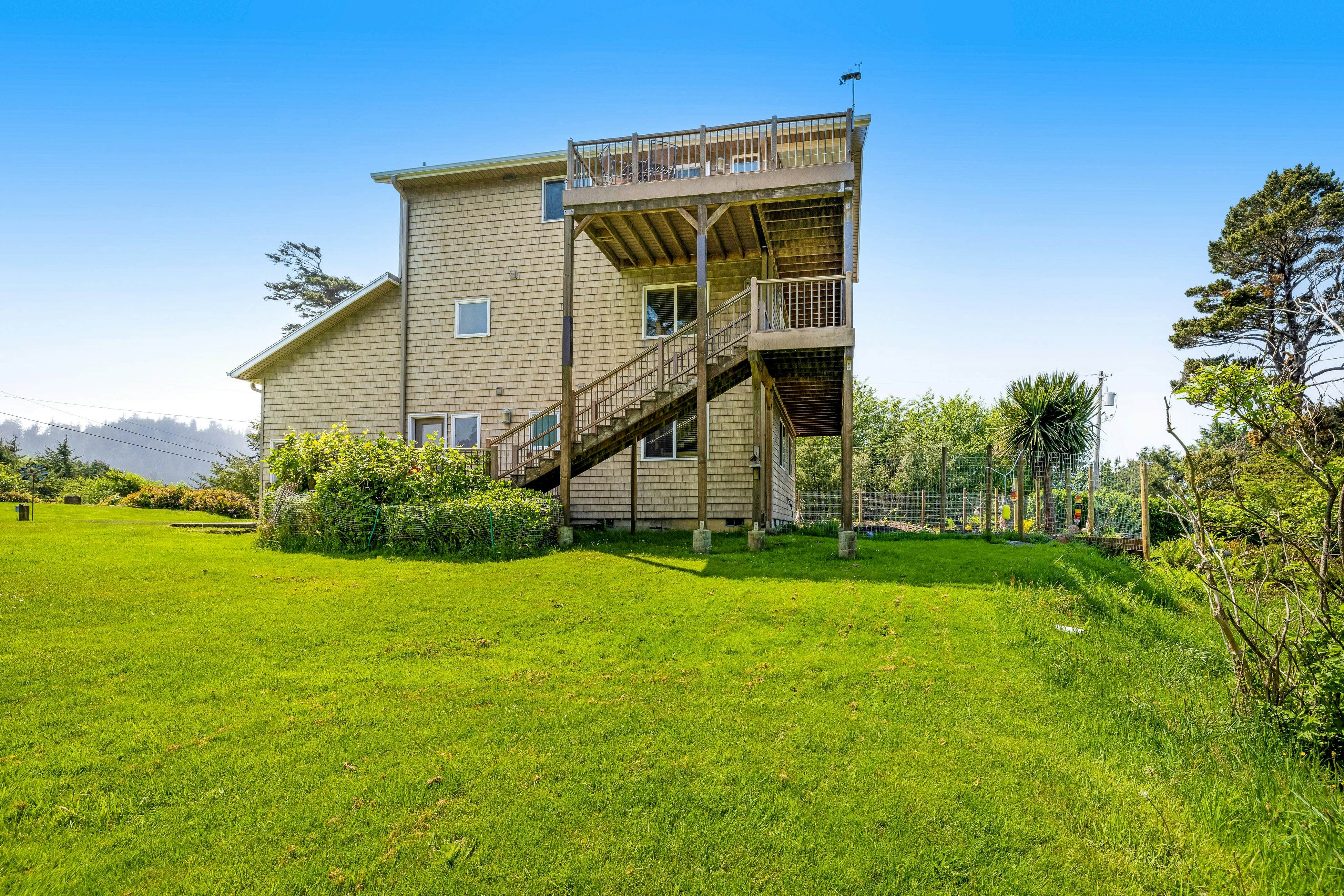 Lakefront escape with water views, grill, wrap-around deck - walk to beach