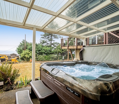 Cozy dog friendly home with ocean views a private hot tub and washer and dryer