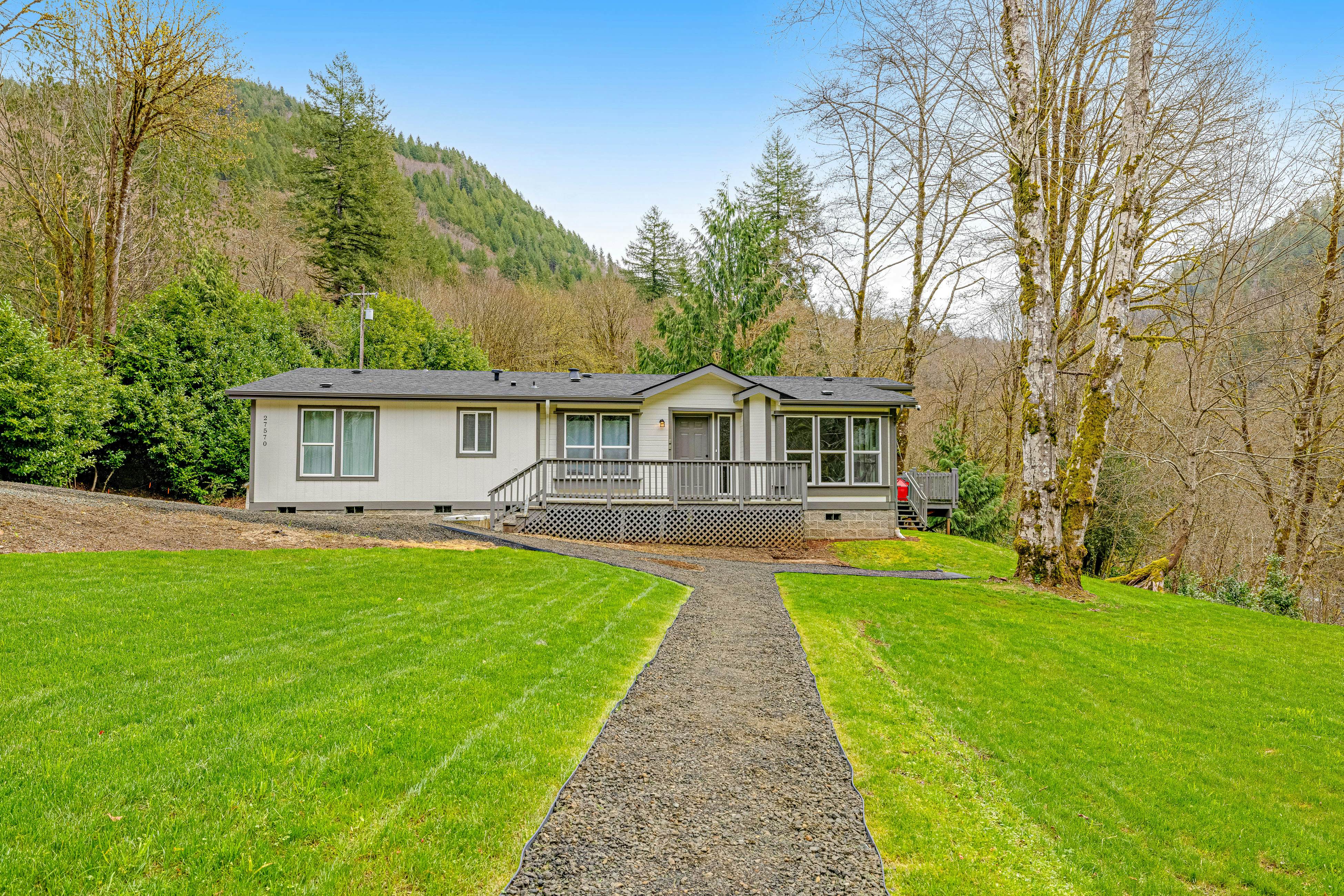 Dog-friendly, waterfront home on the Wilson River with great views, deck & WiFi