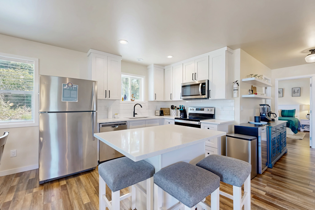 Modern Beach Cottage with a covered patio fire pit grill and easy beach access