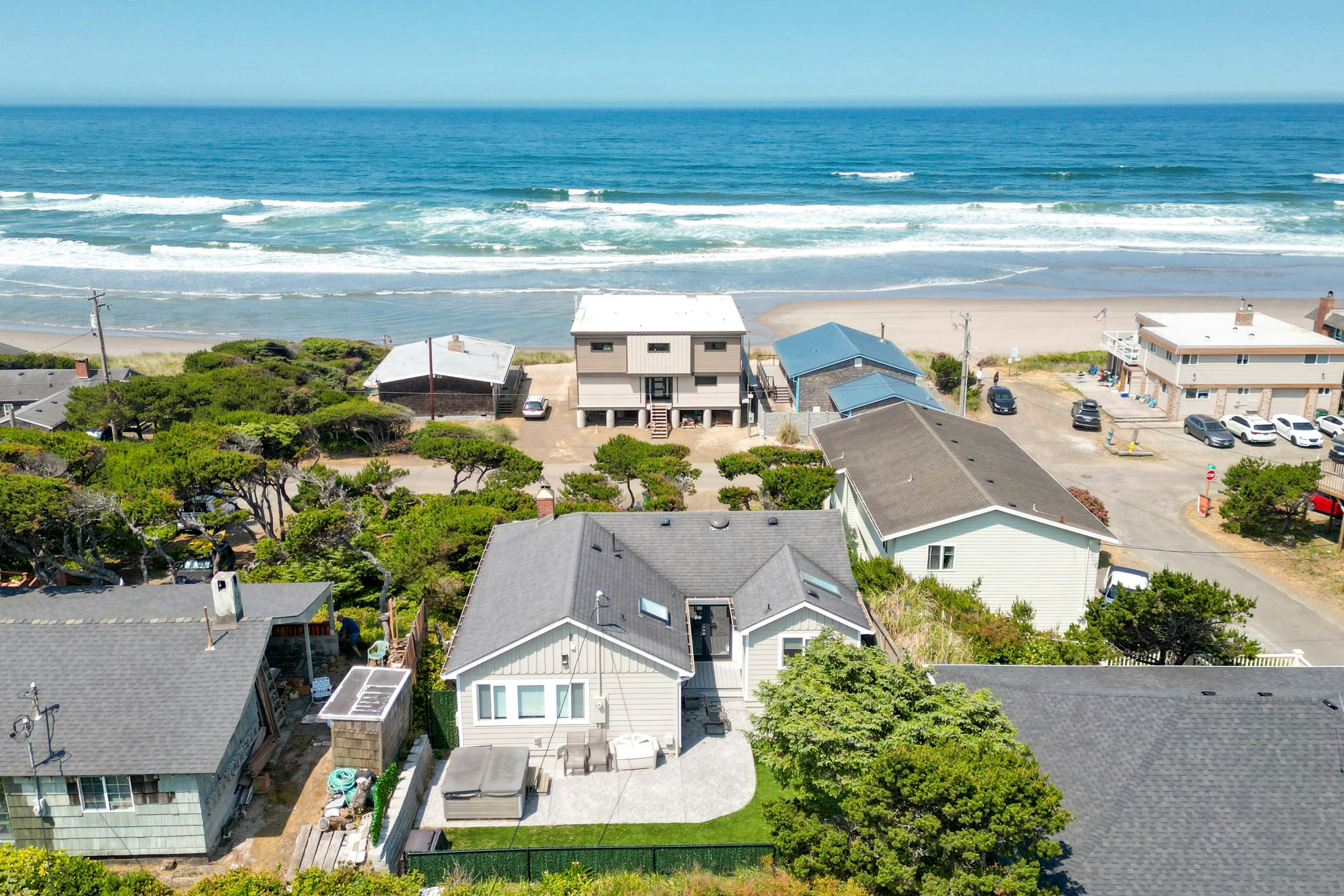 Renovated lake/ocean-view retreat with hot tub, outdoor living & fireplace