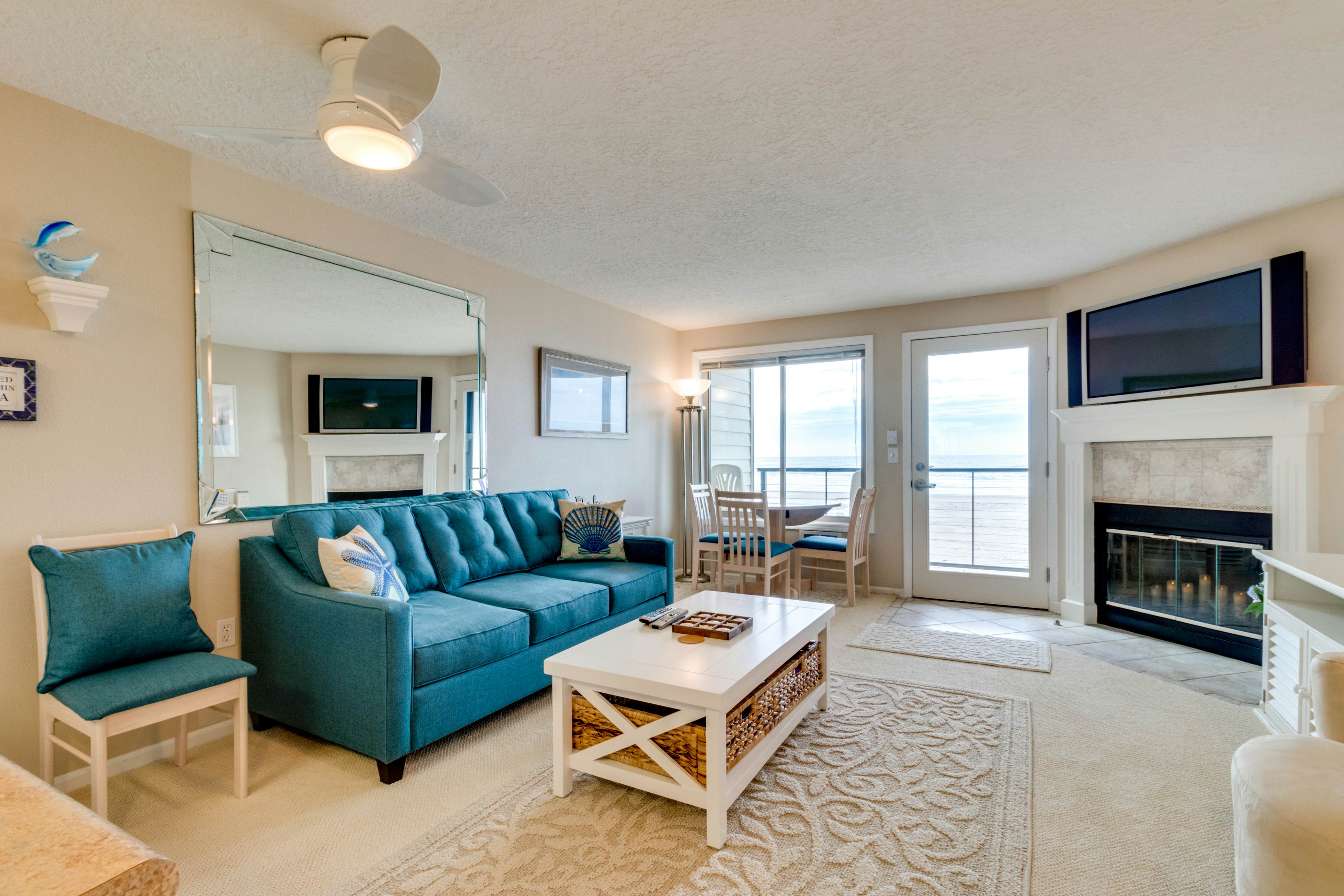 Oceanfront condo with a full kitchen, balcony, & sweeping sea views