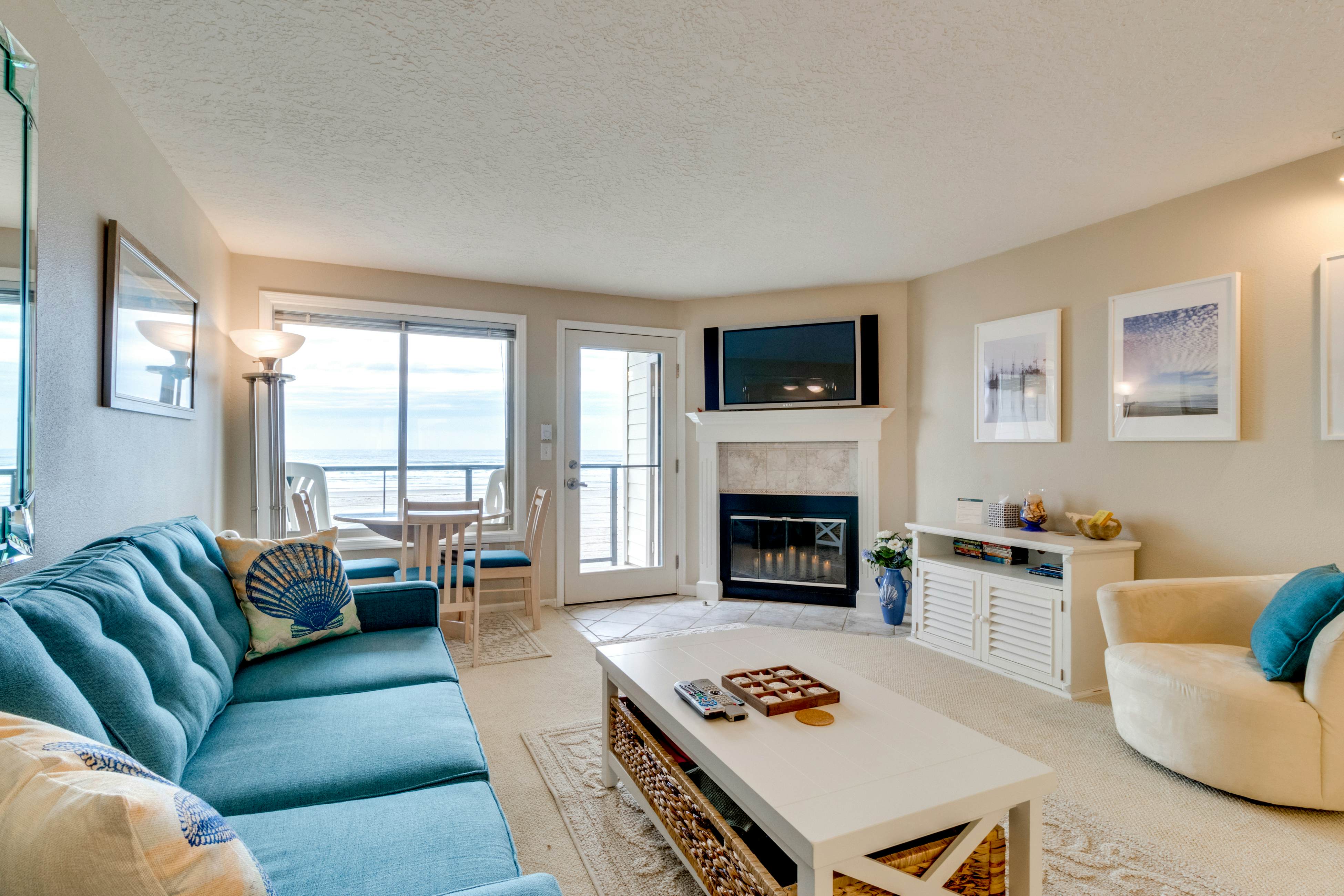 Oceanfront condo with a full kitchen, balcony, & sweeping sea views