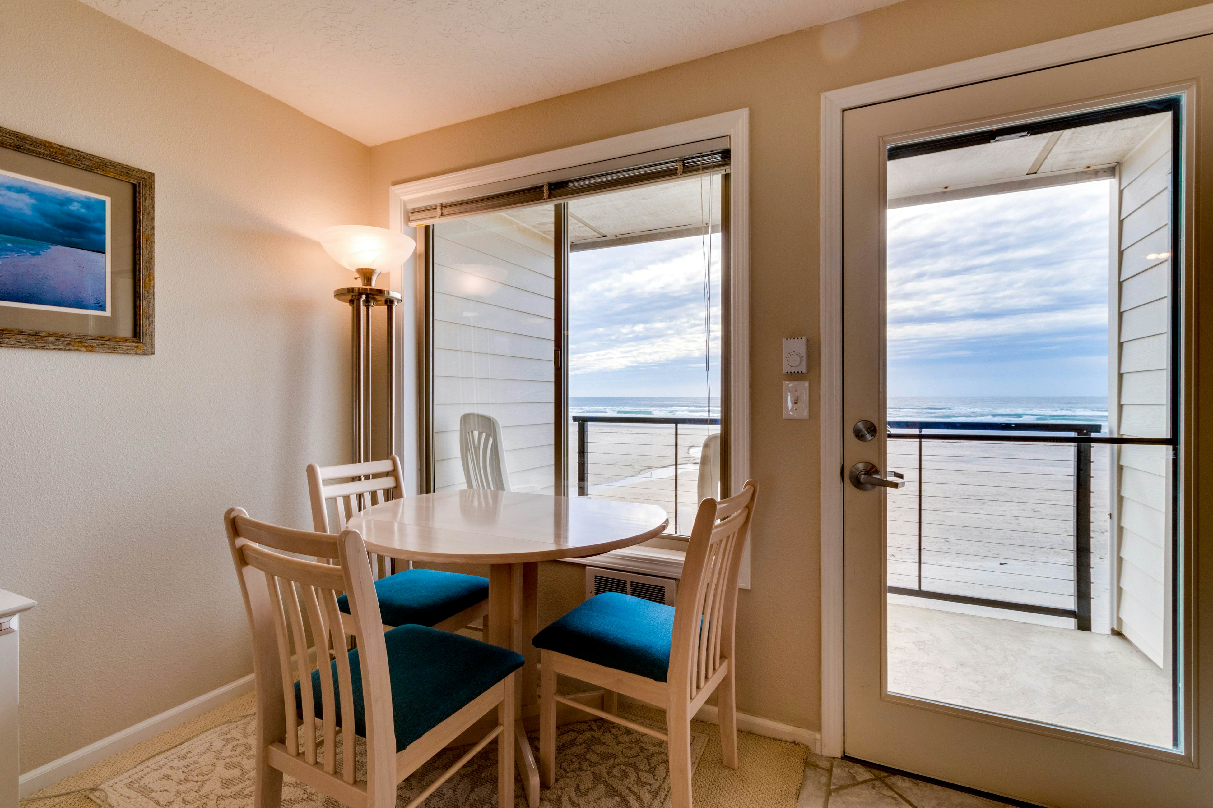 Oceanfront condo with a full kitchen, balcony, & sweeping sea views