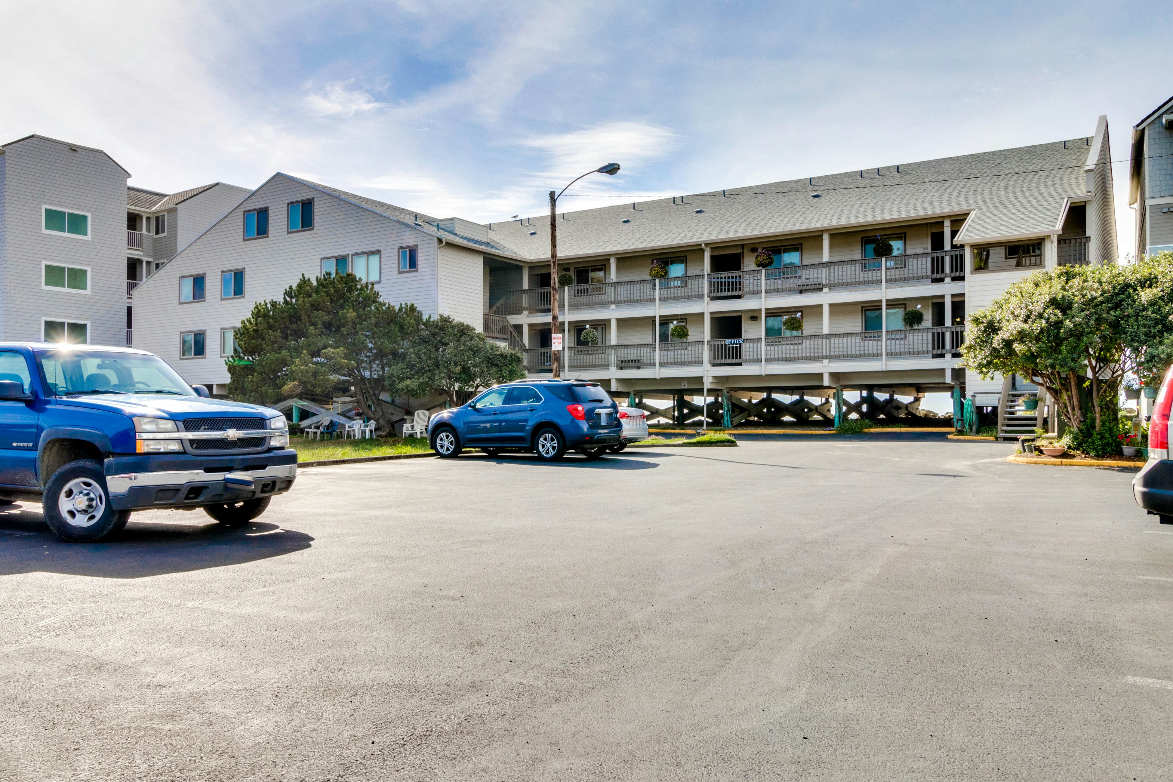 Oceanfront condo with a full kitchen, balcony, & sweeping sea views