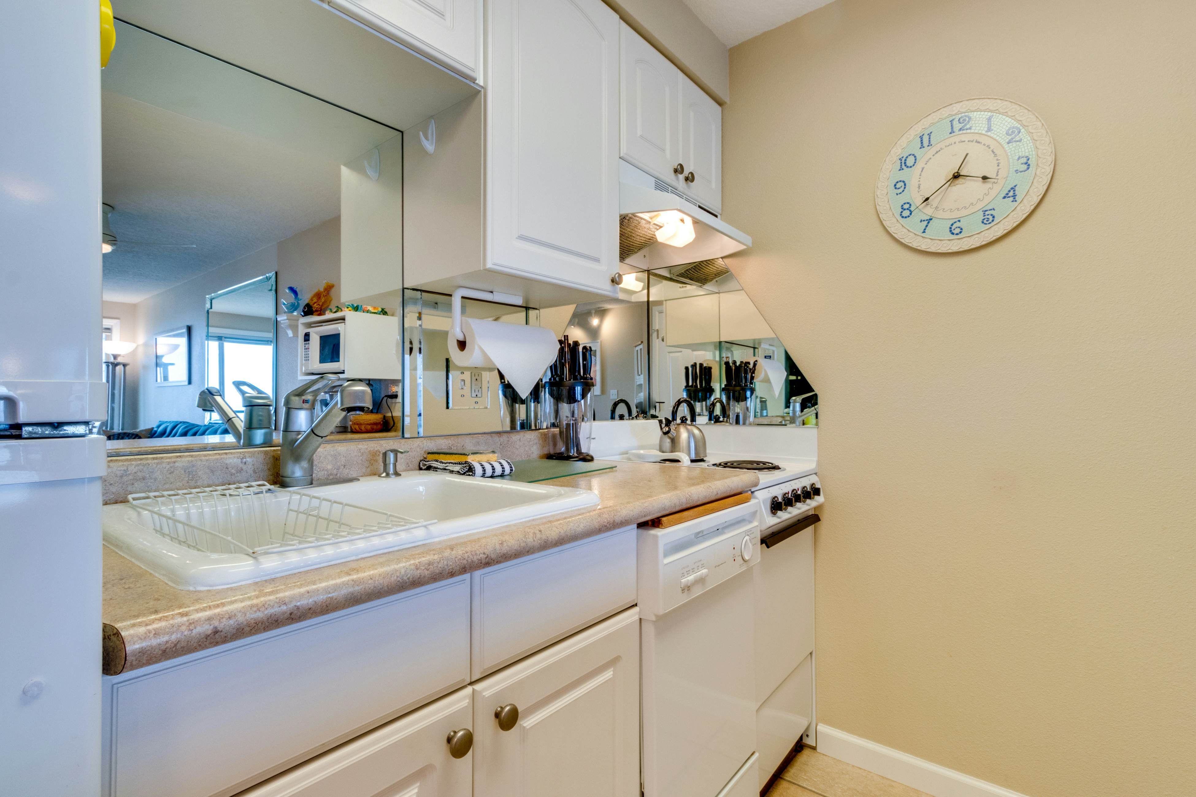 Oceanfront condo with a full kitchen, balcony, & sweeping sea views