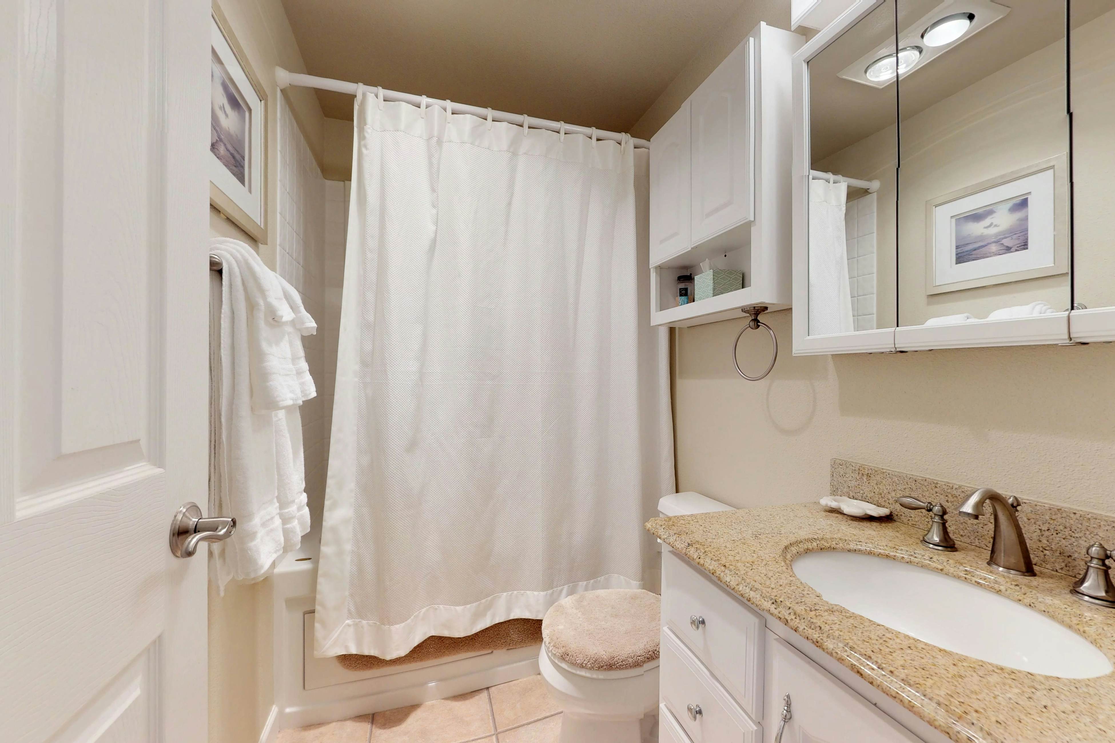 Oceanfront condo with a full kitchen, balcony, & sweeping sea views