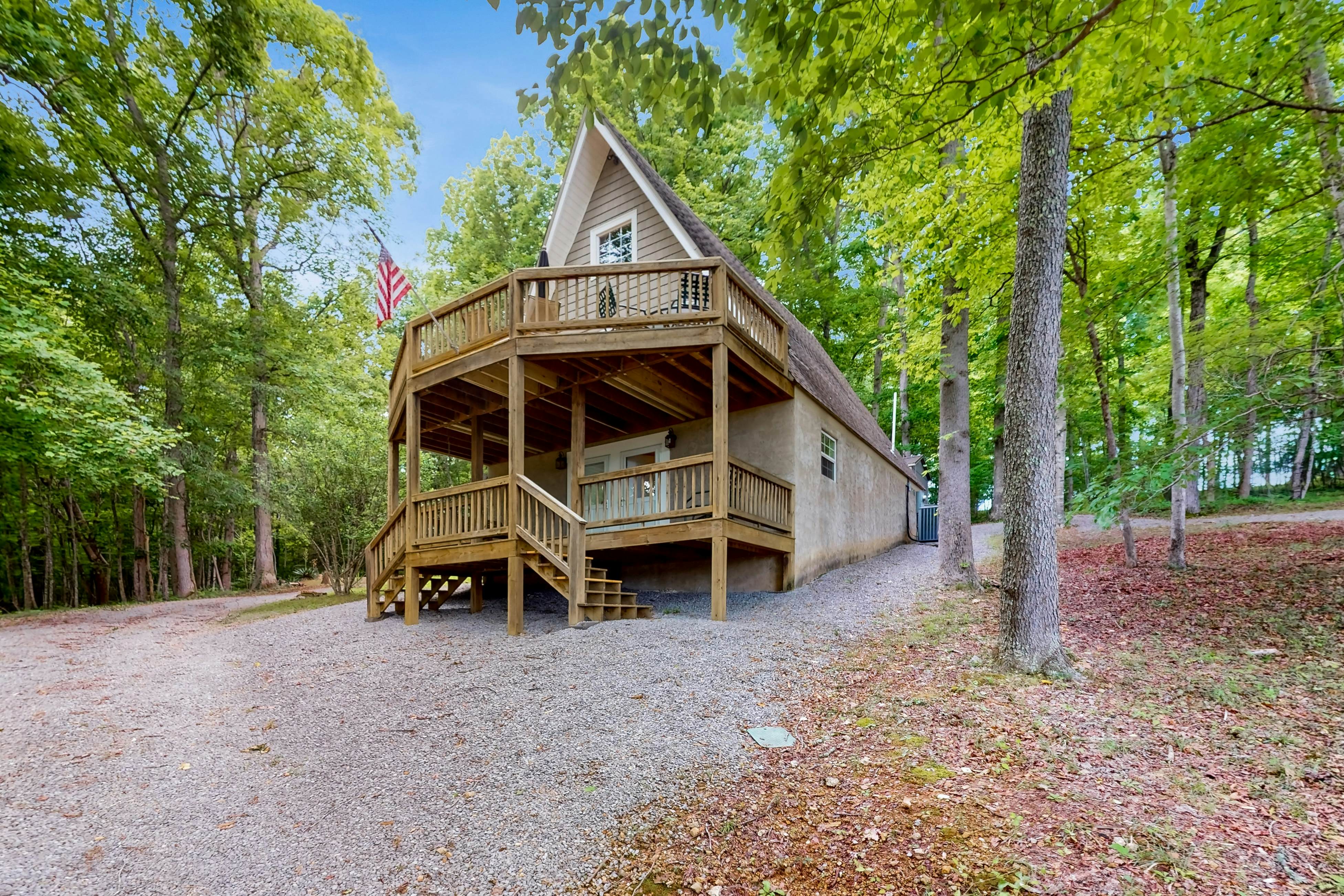 Cozy A-frame home with fire pit, deck, pickleball court, and covered boat slip