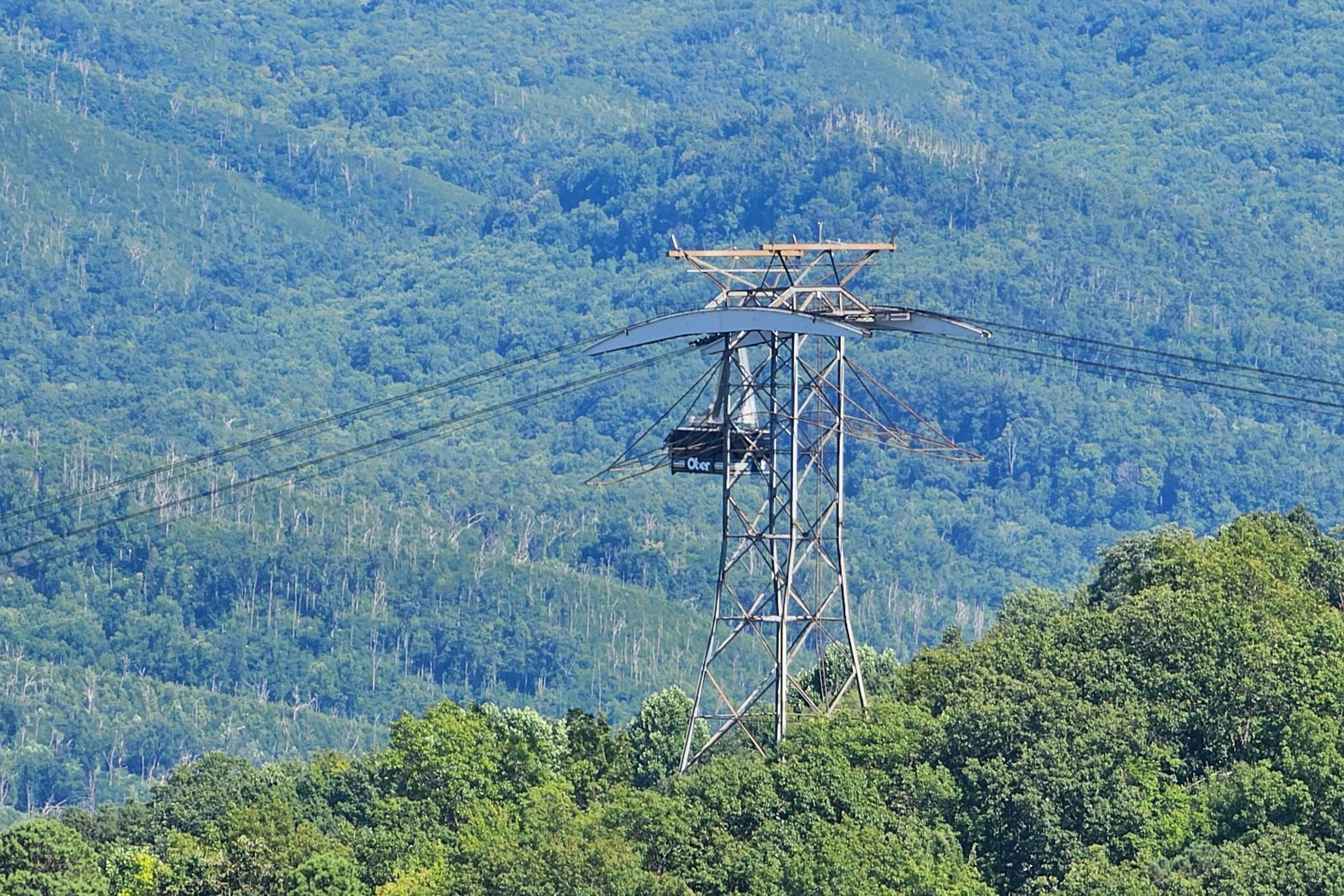 Mountain-view condo with private balcony, pool, & wood-burning fireplace