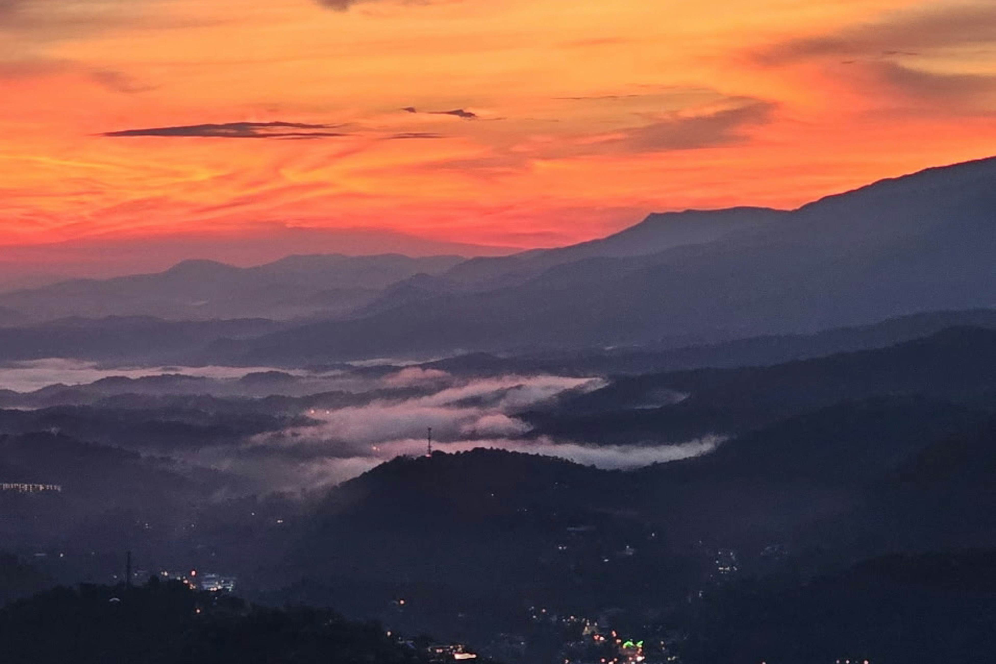 Mountain-view condo with private balcony, pool, & wood-burning fireplace