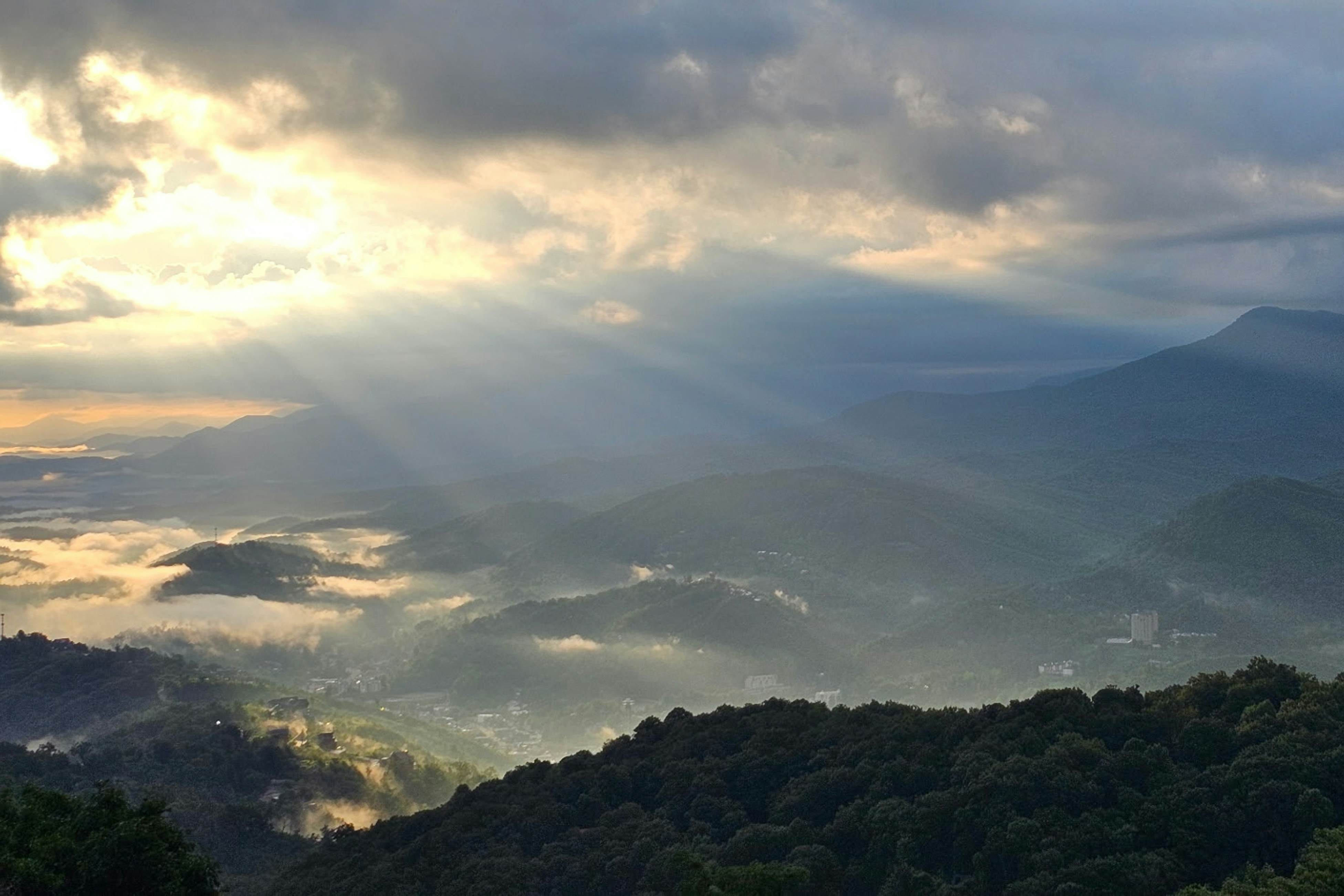 Mountain-view condo with private balcony, pool, & wood-burning fireplace