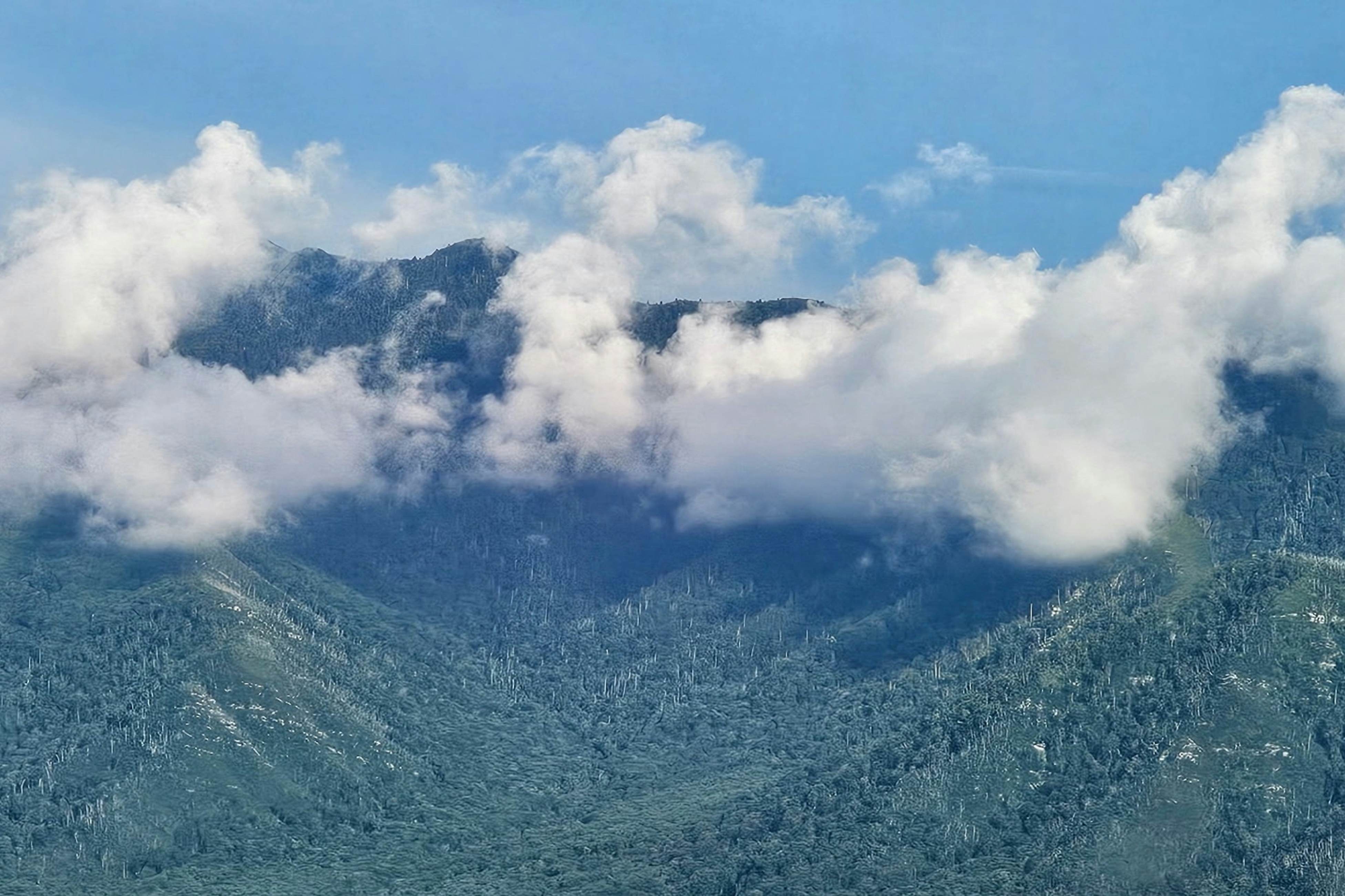Mountain-view condo with private balcony, pool, & wood-burning fireplace