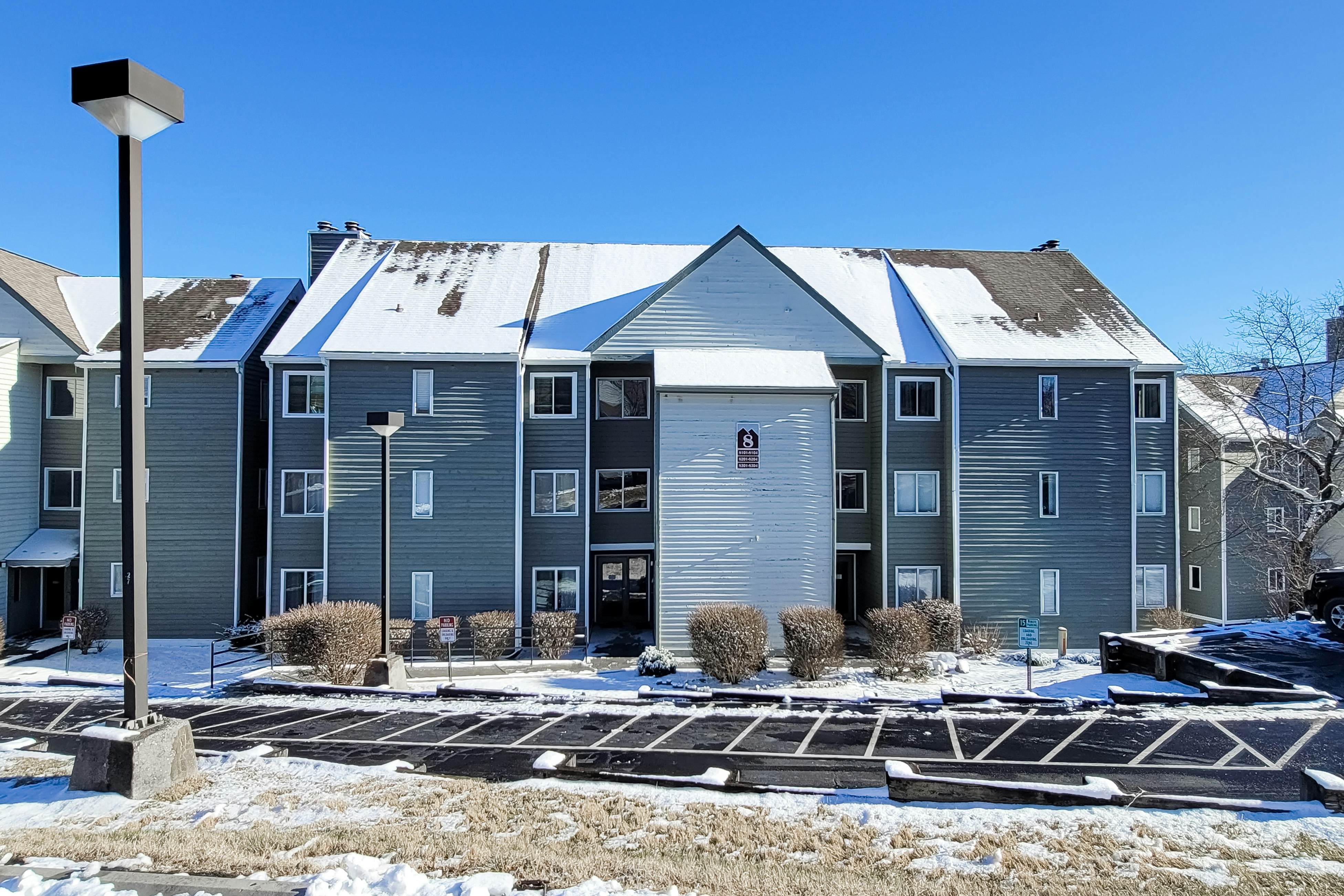Mountain-view condo with private balcony, pool, & wood-burning fireplace