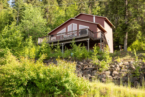 Wake Up to Spectacular Lake Views — Your Private Group Sanctuary at Lake Coeur d'Alene. This 4-bedroom, 3-bathroom home sleeps 12 across three stories with multiple living areas, purpose-built for multi-generational gatherings, extended family holidays, and friend groups. Dogs are absolutely welcome.