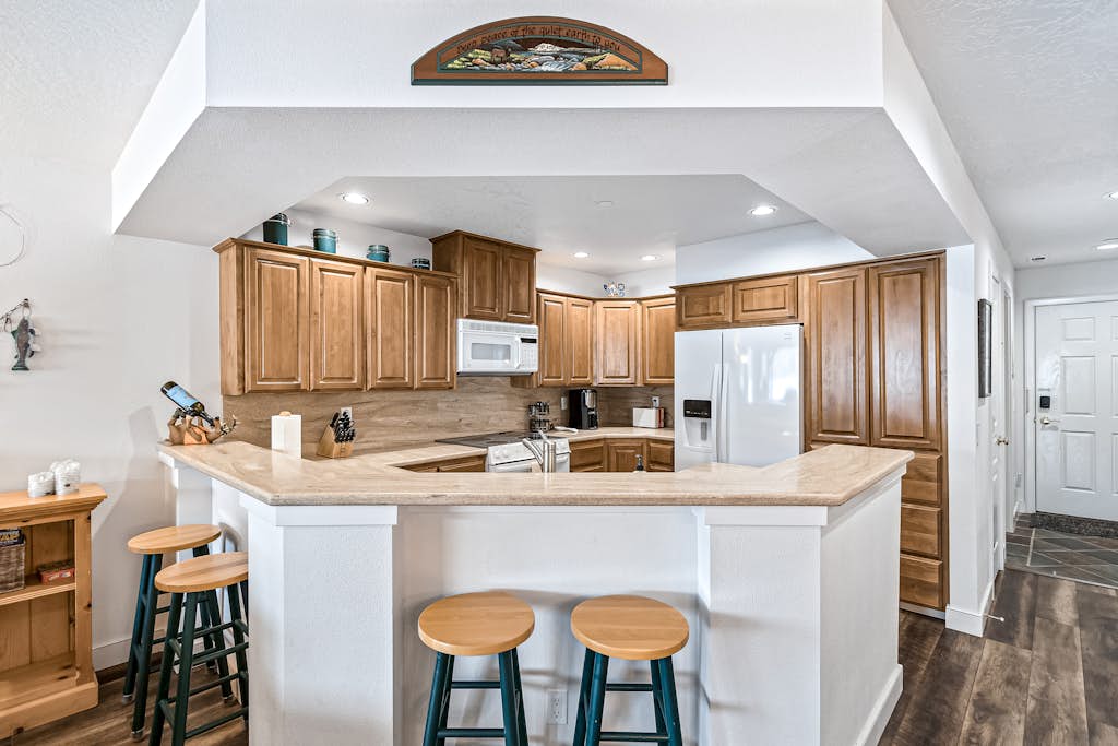 Lakefront Condo with Balcony & Mountain Views