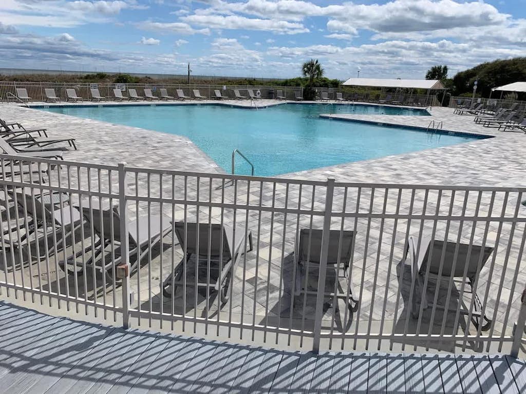 Relax in a bright, white, and airy 2BR villa perched on the 4th floor of Admiral’s Row. This ocean-view property puts you steps from the sand and the island's best amenities. From the king-sized master suite to the breezy balcony, every detail is designed for comfort. Enjoy the playground, fitness center, and seasonal ice cream stand, all within a secure, gated community on the Atlantic coast.
