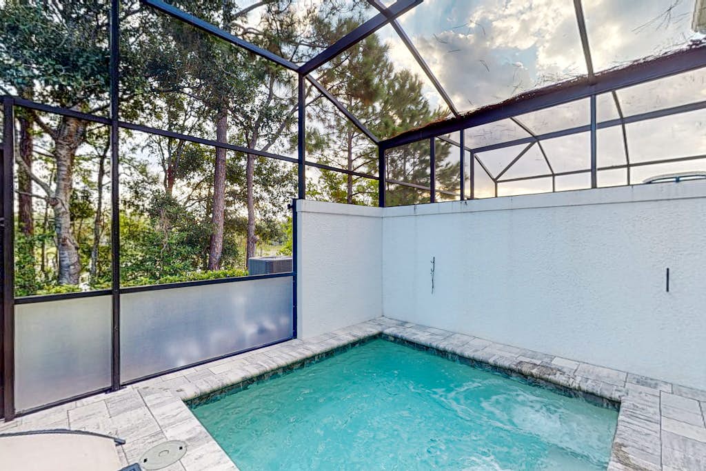 Dog-friendly retreat with pool, covered patio, children's items, grill, and AC