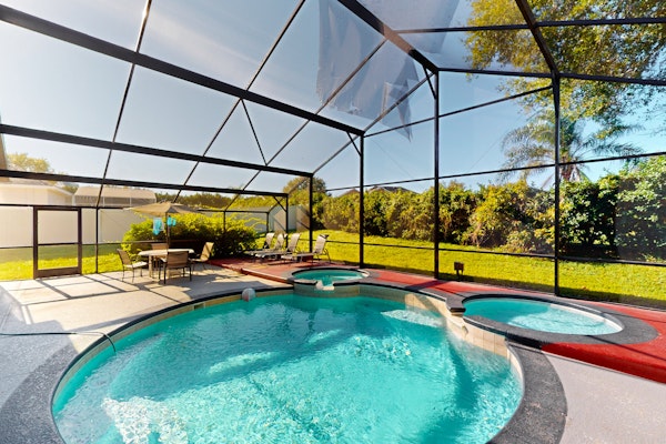 Spacious home with game room and mickey shaped pool and gas grill